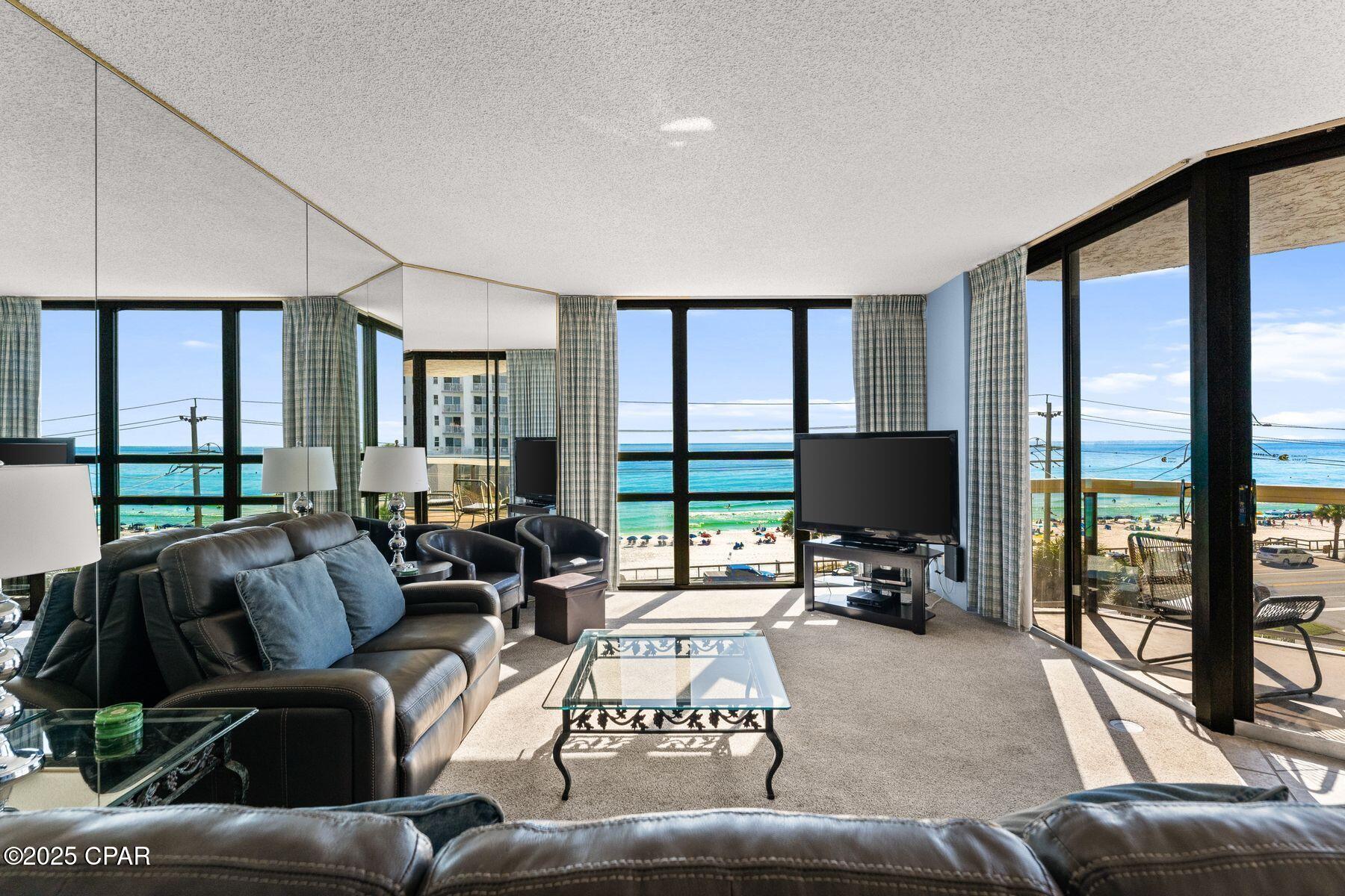 Panoramic gulf views define this versatile three-bedroom residence in Surfside Resort, where every bedroom and the main living area open to a balcony overlooking the sugar-white sand and emerald waters below. Designed for both enjoyment and investment, the unit offers a flexible lockout configuration—rent it as a full three-bedroom, three-bath condominium or as separate two- and one-bedroom suites to maximize income potential. The interior features a bright coastal palette with tiled counters, updated appliances, and generous gathering spaces that frame the water beyond. Each bedroom offers its own balcony access, ideal for morning coffee or sunset views that stretch across the horizon. Surfside Resort is celebrated for its full suite of resort amenities, including a beachfront pool and hot tub, private beach access, fitness center, 2 private tennis courts and shuffleboard courts, and on-site dining at Royal Palm Grille. Guests and owners also enjoy the convenience of covered parking, interior corridors, and the indulgence of an in-house spa and salon. This turn key condominium captures the essence of effortless gulf-front living.
