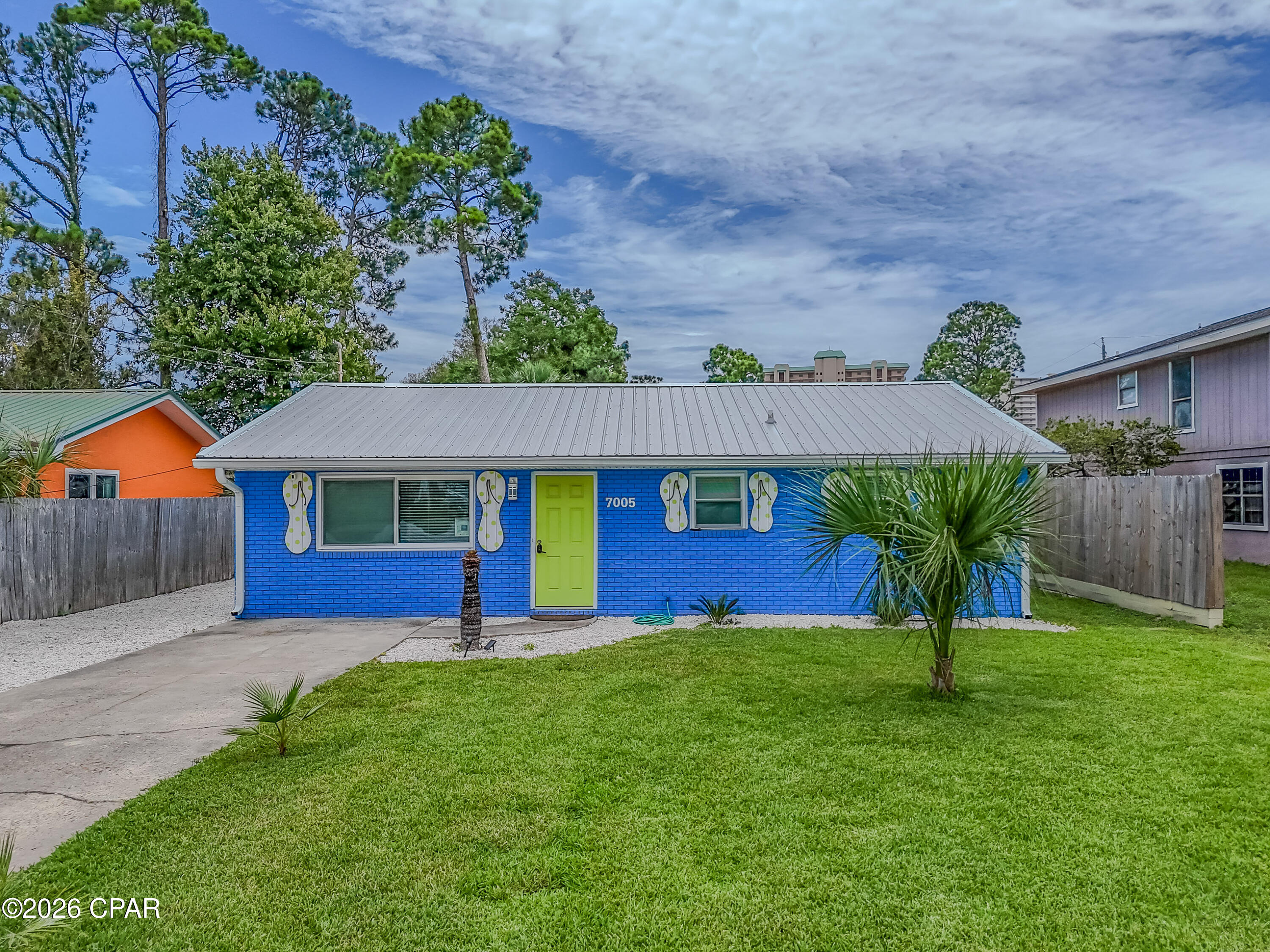Welcome to The Flip Flop House, a proven vacation rental opportunity just minutes from the sugar-white sands of Panama City Beach. Offered fully furnished and already established as an Airbnb ''Guest Favorite,'' this turnkey property is ready to start generating income from day one. Featuring 3 bedrooms and 2 bathrooms, this beautifully updated beach retreat combines coastal charm with smart investment appeal. Guests love the prime location that is nestled in a quiet neighborhood with no HOA restrictions, yet within walking distance of public beach access (Richard Selzer Park), and just minutes from St. Andrews State Park, waterfront dining, shopping, and local attractions. Inside, you'll find a bright and inviting interior with coastal-inspired finishes, spacious bedrooms, and a thoughtfully renovated kitchen showcasing granite countertops, white shaker cabinetry, custom tile backsplash, and upgraded stainless steel appliances. Luxury vinyl plank flooring runs throughout the home, providing durability and easy maintenance ideal for short-term rental use. Enjoy tranquil views of Grand Lagoon from the property, adding to the relaxed coastal atmosphere guests seek. Recent improvements include updated bathrooms, impact-resistant vinyl windows, a metal roof installed in 2022, and dual water heaters for added guest comfort. Outside, the large backyard offers plenty of space for entertaining, grilling, and relaxing under the covered patio. Boat owners will appreciate the on-site boat parking and the public boat ramp located just two blocks away, making it easy to enjoy fishing, boating, and waterfront adventures. Whether you're looking to expand your investment portfolio, secure a vacation getaway, or own a beach home with strong rental potential, The Flip Flop House delivers location, updates, and income-producing opportunity all in one package.