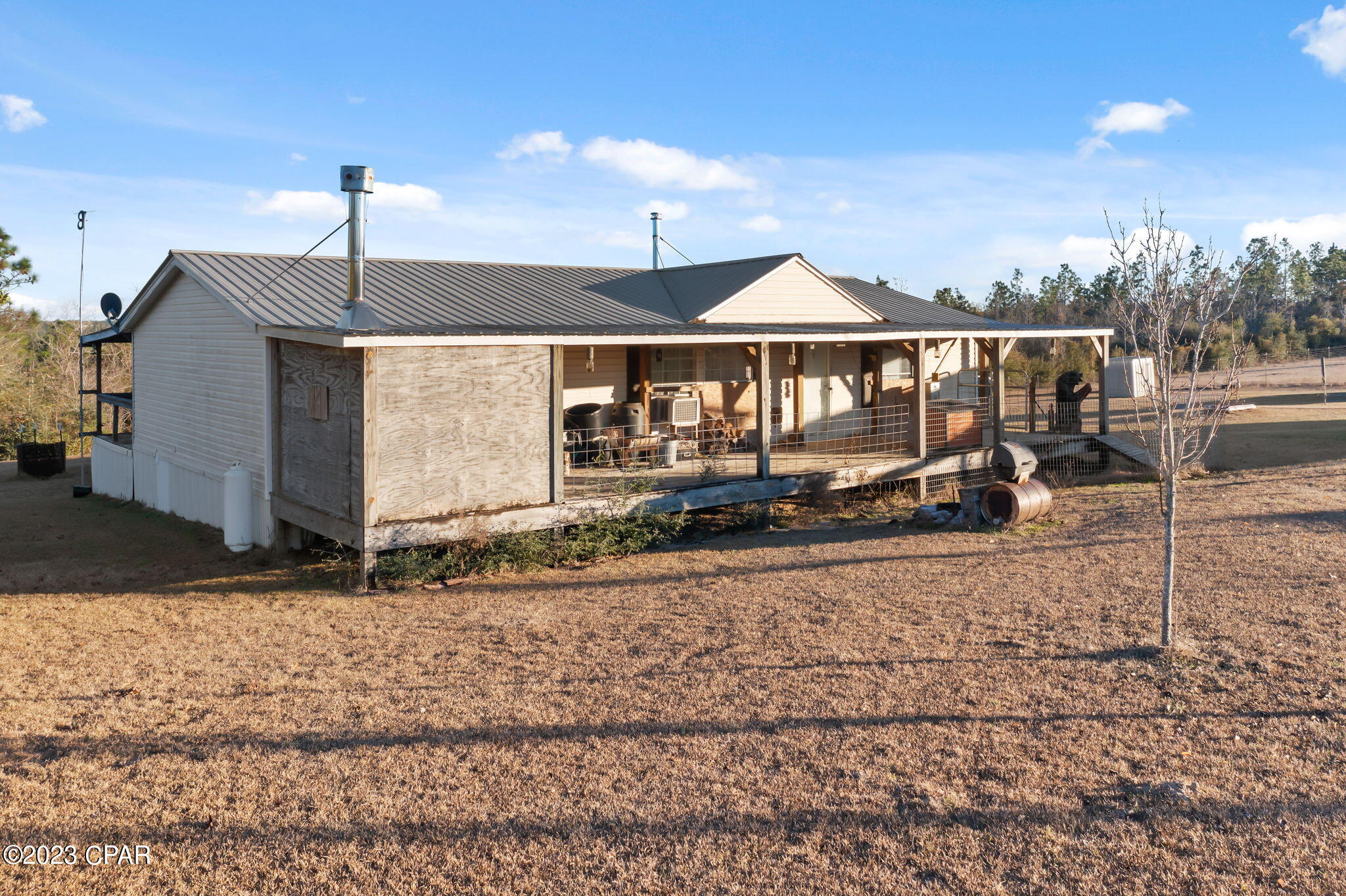 This beautiful 6+/- acre property has everything needed to live the country life! Located just minutes from Chipley this 3 bedroom, 2 bath mobile home boasts a spacious living room, kitchen with an abundance of cabinetry and dining with woodburning stove. The split floor plan provides plenty of privacy for the master suite that features walk-in closet, shower and double vanities. Outside features include large, covered front and back porches, dry sauna, storm shelter, multiple storage sheds, garden and 36x36 pole barn. Property is located off Orange Hill Road, just a short drive to Hwy 77 and Interstate 10.