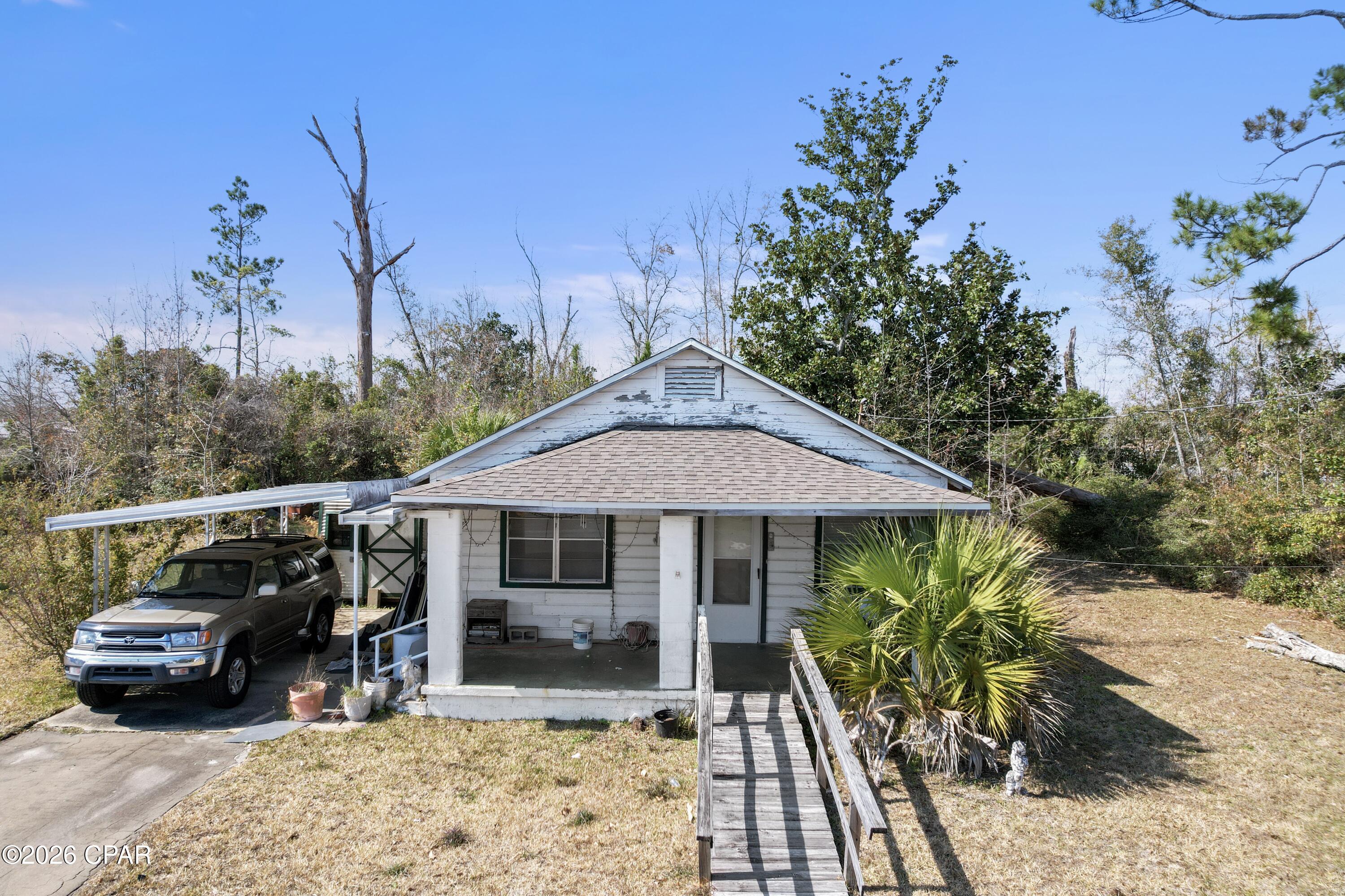 Welcome to 1408 Alabama Ave, a treasured home in the heart of sought-after Lynn Haven. Built in 1950 and lovingly maintained by the same family, this solid cinderblock home—full of character and rich with history—awaits a new vision. While it needs some work, it offers incredible potential. Nestled on over half an acre by itself, it can also be sold alongside 1412 Alabama Ave, creating a total of 6 lots—three on each property—spanning over an acre. This is a rare investment opportunity in a prime location—bring your vision and let this home flourish once again!