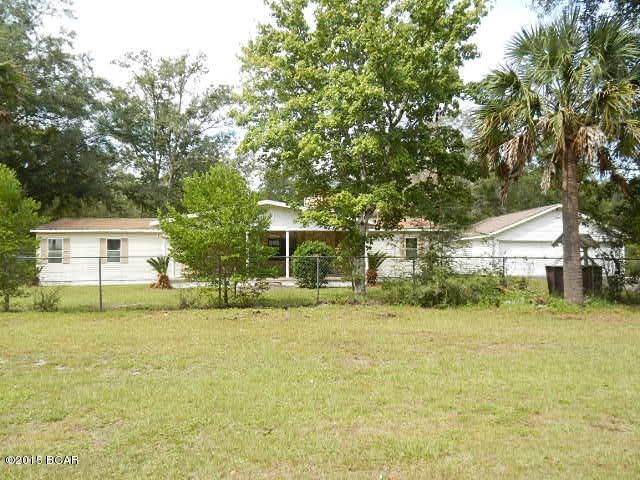 Huge doublewide means you can literally bring everything you own plus some!  Layout includes a formal living room w/stone fireplace, eat-in kitchen/family room combo w/full bathroom, utility room, closet pantry, and French doors that open to an enormous sunroom, 3 spacious bedrooms w/reach-in closets, and a luxury master suite w/reach-in and walk-in dressing closets and a master bath w/jetted tub, separate shower, and dual sinks.  Bring fresh flooring and move right in! Very secluded area perfect for the outdoor lover.  This home is just a few minutes from Port St. Joe, Apalachicola, and both the Brothers and Apalachicola Rivers!  Bring the boat because there is endless fishing and boating opportunities all around you plus a boat ramp just a few blocks away! EQUAL HOUSING OPPORTUNITY