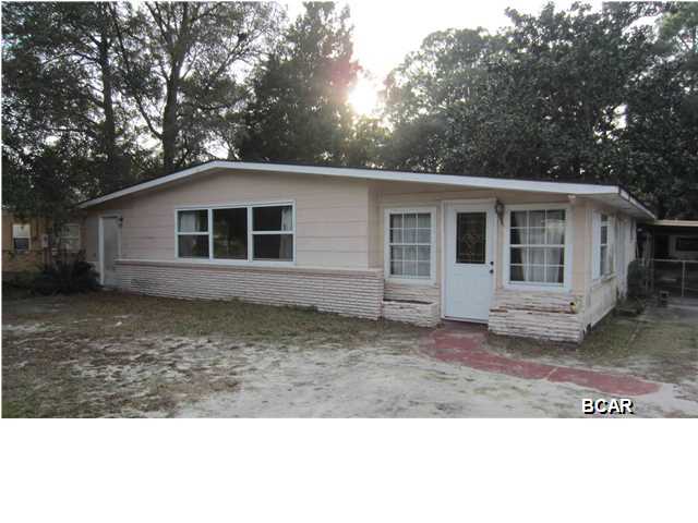 Centrally located three bedroom two bath home with potential. Hardwood laminate flooring throughout, vinyl kitchen floors, and tiled bathrooms. Fenced back yard with covered patio adjoining attached carport, greenhouse and storage building. Roof needs replacement. Home was built prior to 1978, therefore LBP potentially exists.