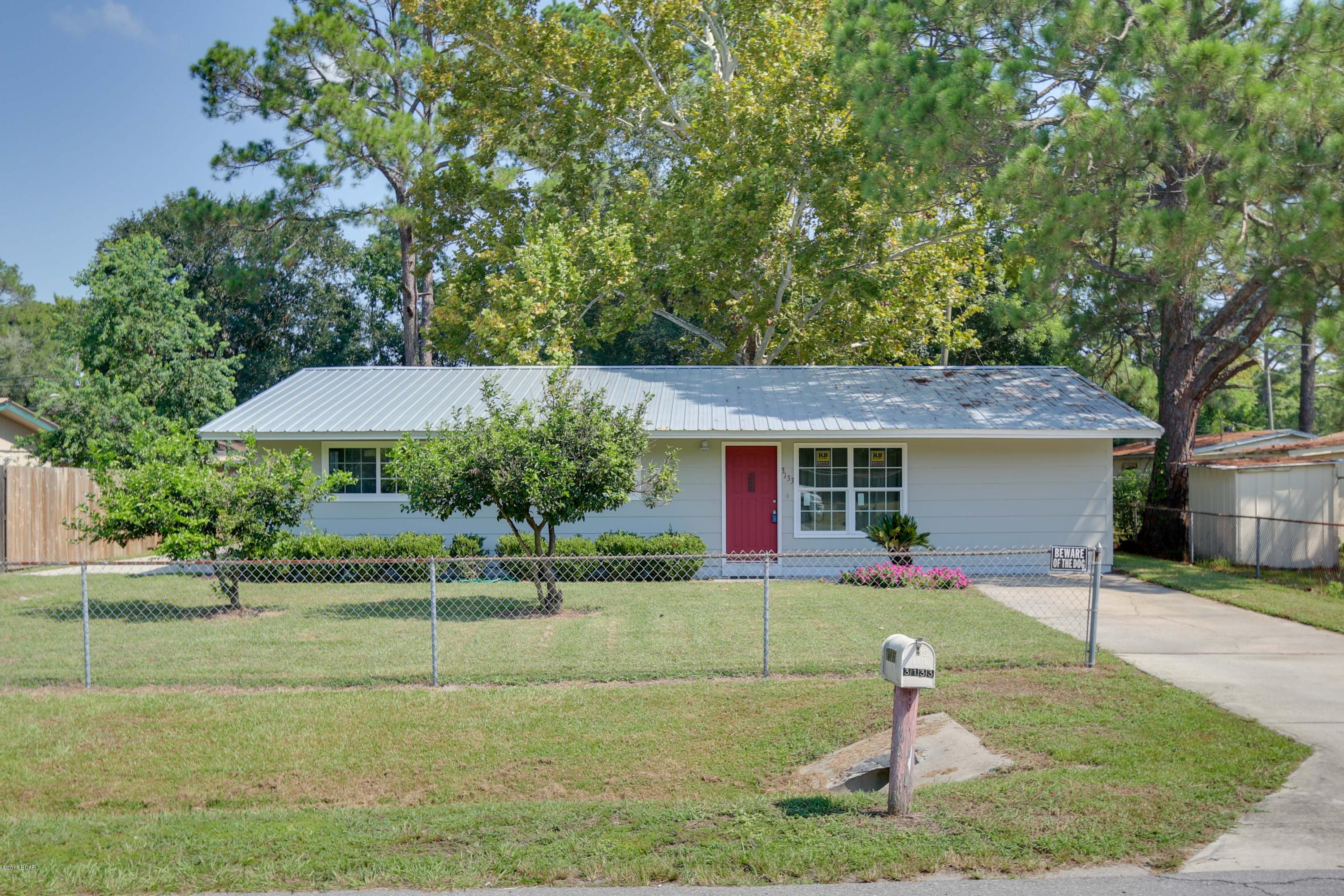Renovated home near Rutherford High School and convenient to Tyndall AFB.  Perfect starter home updated for new buyer!  Three bedroom and one bath home with lots of natural light shining through the new windows.  The home has been finished with new interior paint in hues of off white and soft green.  The exterior paint has been updated to grey with a striking red front door. The master bedroom is huge with three closets for the larger wardrobe.  There is a huge detached garage / workshop with electric power. New Metal Roof with 25 year warranty, new 2 ½ Ton York Guardian Heat Pump 13 SEER system with 10 year warranty, new Oak kitchen cabinets with breakfast bar, new Frigidaire appliances (26 cu ft side-by-side Refrigerator, glass top stove,  dishwasher, rangehood, range), new sinks, more: new faucets and countertops.  There is a concrete patio in the back right outside the kitchen door for grilling and chilling in the fenced yard.  
Please see additional upgrades in list below:
New Energy Star double pane Windows
New laminate (Hickory) wood floors in living room 25 year warranty
New carpet in bedrooms
New ceiling fans & light fixtures throughout
New freshly painted in/outside
New electric outlets & door knobs
New crown/base molding
Huge detached garage/workshop
Fenced in yard
Don't let this one get away!  Call your Realtor today for a private showing!  Room sizes and square footage are approximate.  If important, please measure.