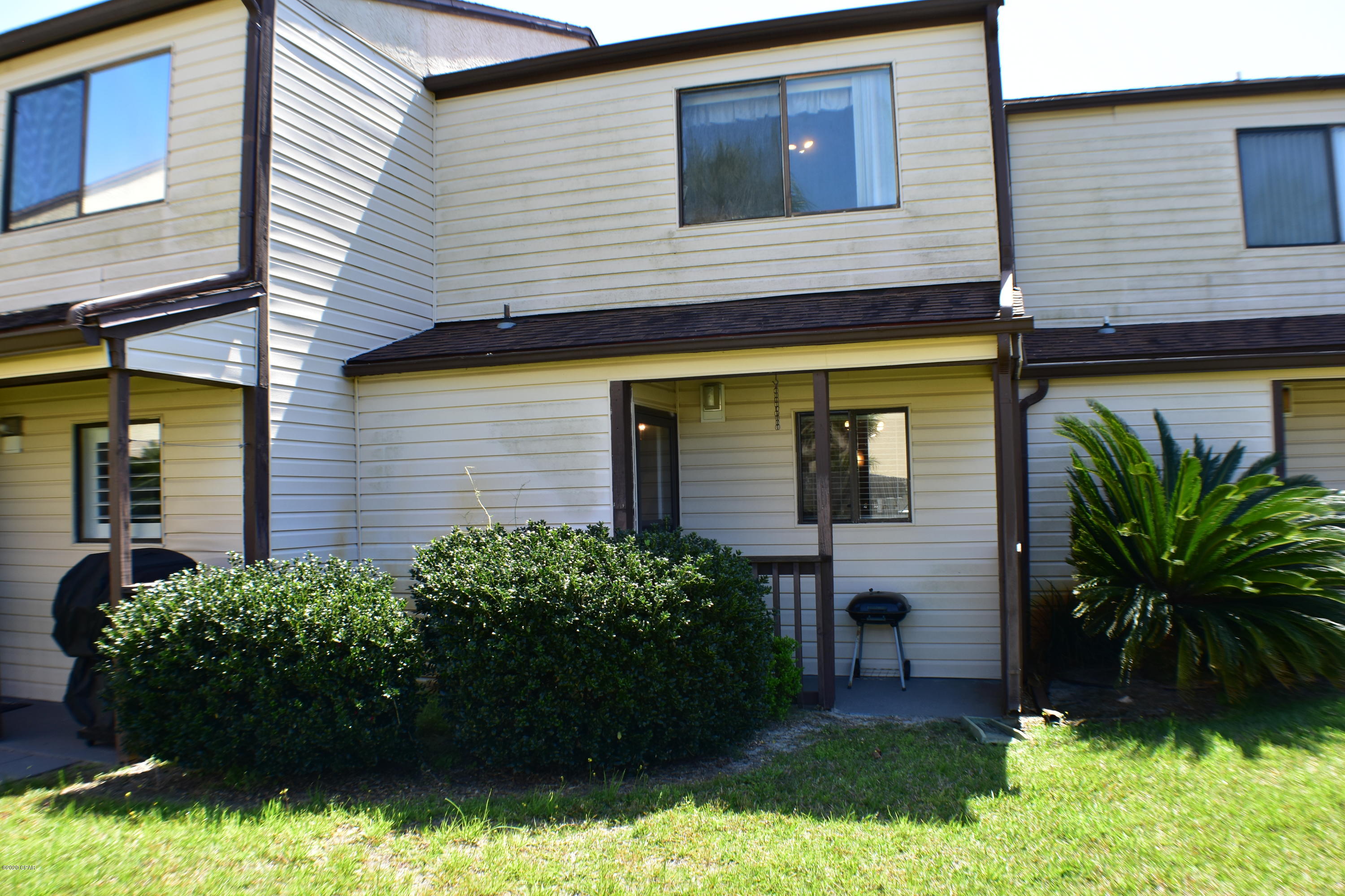 Great second home or investment potential with this Portside Condo!  This 2BR/1.5BA has never been a rental, fully furnished, has upgraded upscale kitchen cabinetry, granite counters and tile backsplash, the first floor has newer tile with decorative accents, and the washer and dryer are included!  There is a balcony off the Master Bedroom, a covered front porch and a covered back porch.  The unit is close to a pool and walking distance to the beach! Portside amenities include 3 pools (1 heated), a kiddie pool, hot tub, tennis courts, shuffleboard, and poolside clubhouse. Although this unit has not been rented, other similar units in the complex average annual gross rentals of $25,000+.  All info is approx and must be verified by Buyers if important.