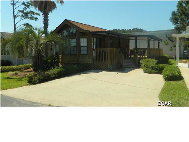 Your very own cabin by the sea awaits in this immaculate Emerald Pointe home. This one bedroom, one bathroom unit offers a few extras including a huge wrap-around deck partially covered, a dishwasher and washer/dryer. The home is being offered fully furnished and has excellent rental history for those looking for investment. All appliances convey. It has tons of built-in storage space and plenty of room for an addition if desired. This is truly a one-of-a-kind in Emerald Pointe.