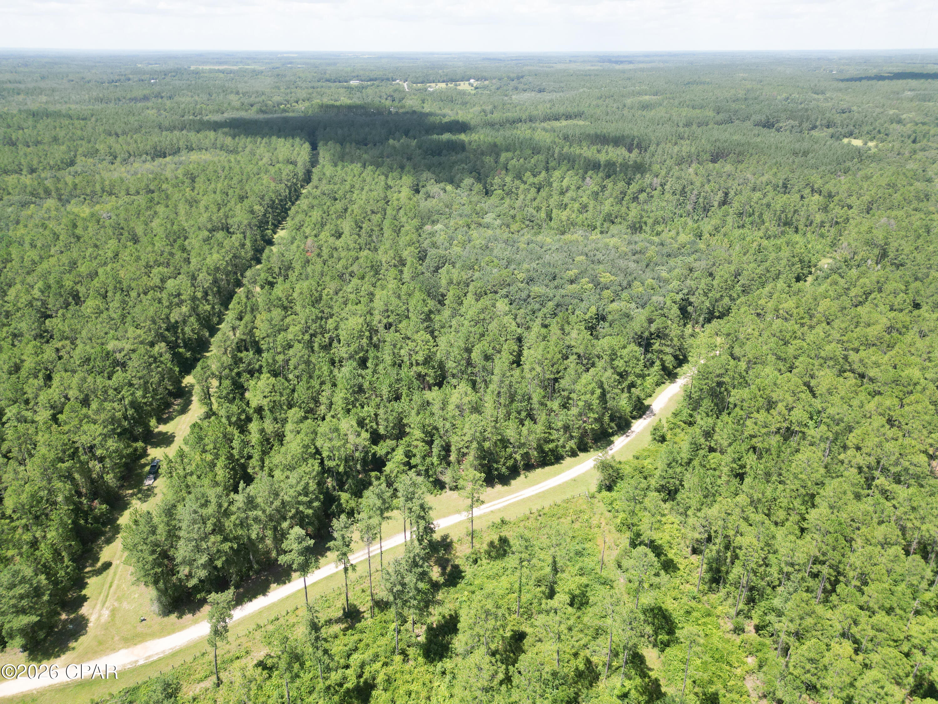 This property is the perfect place to build your dream home on a beautiful 13.38± acre wooded parcel located within the private Canopy Oaks community in Holmes County, Florida. Situated just one-half mile from the main entrance and fronting Hawthorne Trail, a well-maintained dirt road, this acreage offers peace, natural beauty, and the opportunity to enjoy a country lifestyle without sacrificing convenience.
Predominantly high and dry, the property features multiple potential homesites surrounded by mature hardwoods and native pines. With ample room for a custom home, detached workshop, hobby farm, or horses, you'll have the freedom to create the country estate you've always envisioned while enjoying the tranquility of Northwest Florida.
Canopy Oaks is a thoughtfully planned rural community designed to preserve the area's natural beauty while offering residents an exceptional quality of life. Life in Canopy Oaks is all about enjoying the outdoors and a slower pace of living. Miles of riding trails and horse-friendly roads make it easy to saddle up and explore the community, whether you're an experienced rider or simply enjoy having horses close to home. Thoughtful community standards help preserve the beauty of the neighborhood, while the natural surroundings create a peaceful setting where you can enjoy quiet mornings, abundant wildlife, and the simple pleasures of country life. Hunting is not permitted, creating a quiet environment where deer, wild turkeys, and other native wildlife can be enjoyed throughout the year.
Beyond the gates, Holmes County is abundant with outdoor recreation. Spend your weekends kayaking or canoeing along Holmes Creek, swimming in the crystal-clear waters of Vortex Spring or Ponce de Leon Springs State Park, or fishing the Choctawhatchee River.  When you're ready for a day at the beach, the white sands and emerald waters of Panama City Beach are just over an hour away. Shopping, dining, entertainment, and medical facilities are easily accessible in nearby Dothan, Alabama, making this property the perfect combination of rural serenity and modern convenience.
Whether you're looking for a forever home, a peaceful retreat, or a place to enjoy horses and the outdoors, this remarkable property offers the space, privacy, and lifestyle you've been searching for.  Call today for more information.
Key Features:
• 13.38± acres of predominantly high-and-dry wooded land
• Excellent homesite with room for a hobby farm
• Miles of equestrian trails and horse-friendly roads throughout the community
• Frontage on Hawthorne Trail, a well-maintained dirt road
• Site-built homes only (1,400 sq. ft. minimum)
• Approximately 15 minutes to Interstate 10
• Approximately 13 miles to Bonifay
• Approximately 42 miles (about 50 minutes) to Dothan, Alabama
• Approximately 53 miles (about 1 hour) to Panama City Beach
• Close to Holmes Creek, Choctawhatchee River, Vortex Spring, and Ponce de Leon Springs State Park