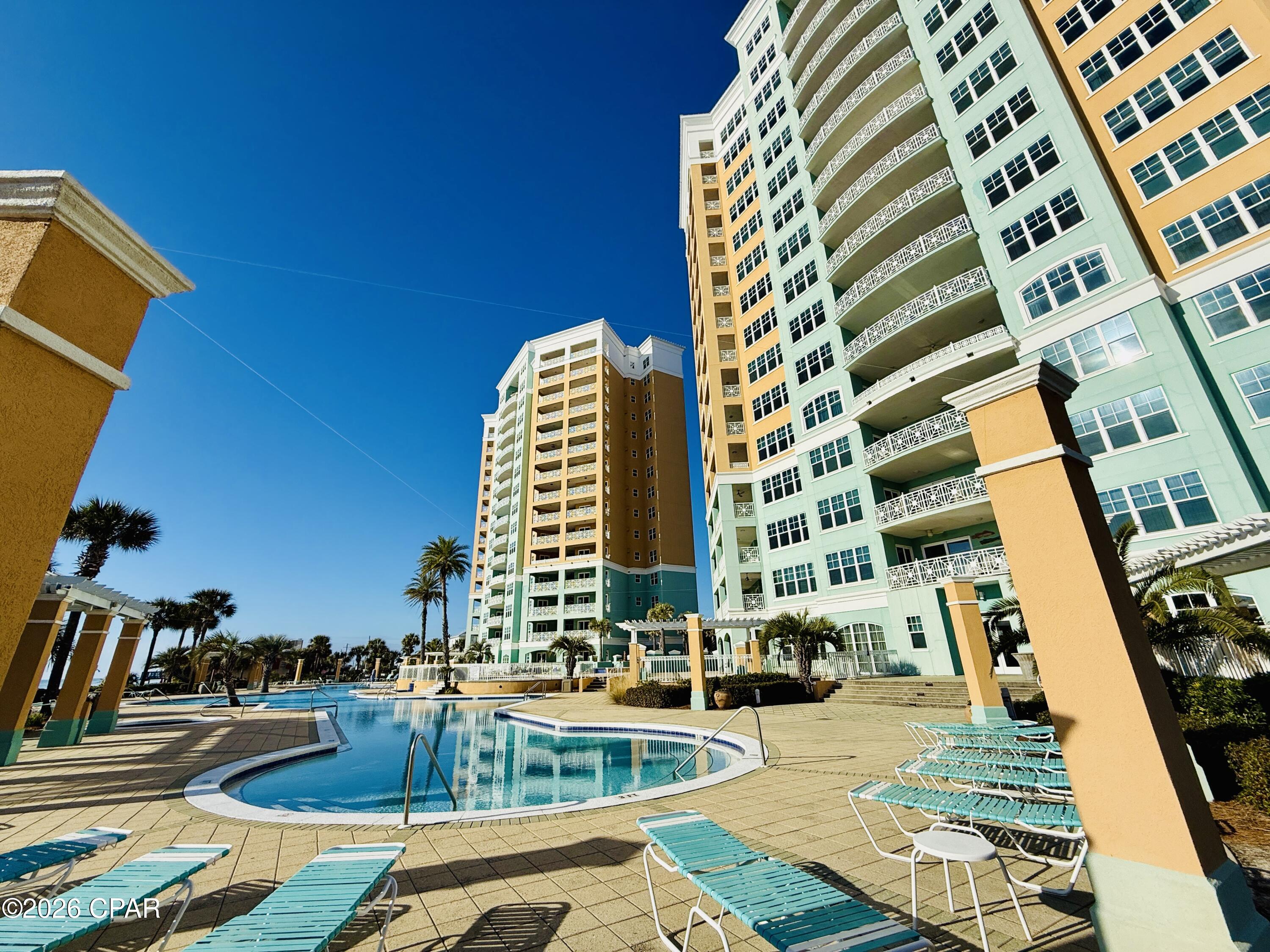 GULF-FRONT PENTHOUSE + EXPANSIVE TERRACE WITH PRIVATE POOL! Welcome to 7505 Thomas Dr, PH 121G, a first-floor penthouse at En Soleil in South of Grand Lagoon on Panama City Beach, offering panoramic Gulf views, 5 bedrooms, 4 en-suite baths, and 3,079 sq ft. Fully furnished, this residence features a 1,700 sq ft private terrace ideal for indoor/outdoor living, with a 16x10 heated pool and outdoor kitchen. The split floor plan provides privacy, while floor-to-ceiling windows fill the space with natural light. Includes deeded garage parking space and a deeded storage room. Strong rental potential with projections up to $150,000 annually and resort-style amenities make this a standout investment or second home, offering a total of 4,779 sq ft of coastal living along the Emerald Coast!

Enjoy expansive Emerald Coast views from the oversized private terrace--perfect for morning coffee or sunset evenings. The newly resurfaced heated pool anchors the outdoor living space, complemented by an outdoor kitchen with grill and partially covered lounge and dining areas designed for year-round entertaining and relaxation.

Recent upgrades include Cat-5 hurricane-rated windows and sliding glass doors (2023), two new HVAC systems (2024), updated baseboards and crown molding, new blinds throughout, exterior patio tile border, freshly painted terrace privacy fence, upgraded pendant lighting, a new gas fireplace, seven new smart TVs, and an additional refrigerator in the private storage room located just outside the front door.

Inside, the open-concept kitchen features an eat-in bar, new refrigerator, wine refrigerator, custom cabinetry, granite countertops, and two dining areas, creating an ideal flow for gatherings. The open layout seamlessly connects the living, dining, and kitchen spaces, supporting both everyday comfort and entertaining.

En Soleil features two 15-story towers with only 88 total units and just 2-3 residences per floor, offering a quiet and private setting. This gated community includes 24/7 security, private beach access with seasonal chair service, two beachfront hot tubs, resort-style pools, a fitness center, conference room, and underground garage parking. This unit includes a deeded garage parking space with elevator access.

Conveniently located near world-class golf, sport fishing, fine dining, and boutique shopping, En Soleil offers over 6,500 square feet of swimming pools, waterfall features, and 450 feet of private sugar-sand beach. From the pool deck, follow the private walkway directly to the Gulf!

Don't miss this rare opportunity to own a penthouse along The Emerald Coast - Schedule your private showing today!