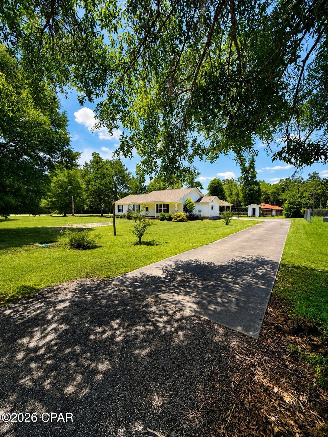 If you've been looking for space, comfort, and a place that feels like home the moment you arrive, this one deserves your attention.
This charming 3 bedroom, 2 bath home offers 1,711 square feet of heated and cooled living space and sits on a spacious .64-acre corner lot. Built in 2007, this property features a large family room perfect for gathering, relaxing, and making memories. Enjoy quiet mornings on the front porch, plenty of outdoor space for kids, pets, or gardening, and the convenience of a 2-car carport. The mudroom and laundry area are conveniently located just off the carport, making everyday living that much easier.
The enclosed utility shed with an outside lean-to provides great storage and workspace options, while the spacious yard gives you room to spread out and enjoy.
With a functional layout, inviting features, and plenty of space inside and out, this home is full of potential and ready for its next chapter. Don't miss your chance to make this one yours!