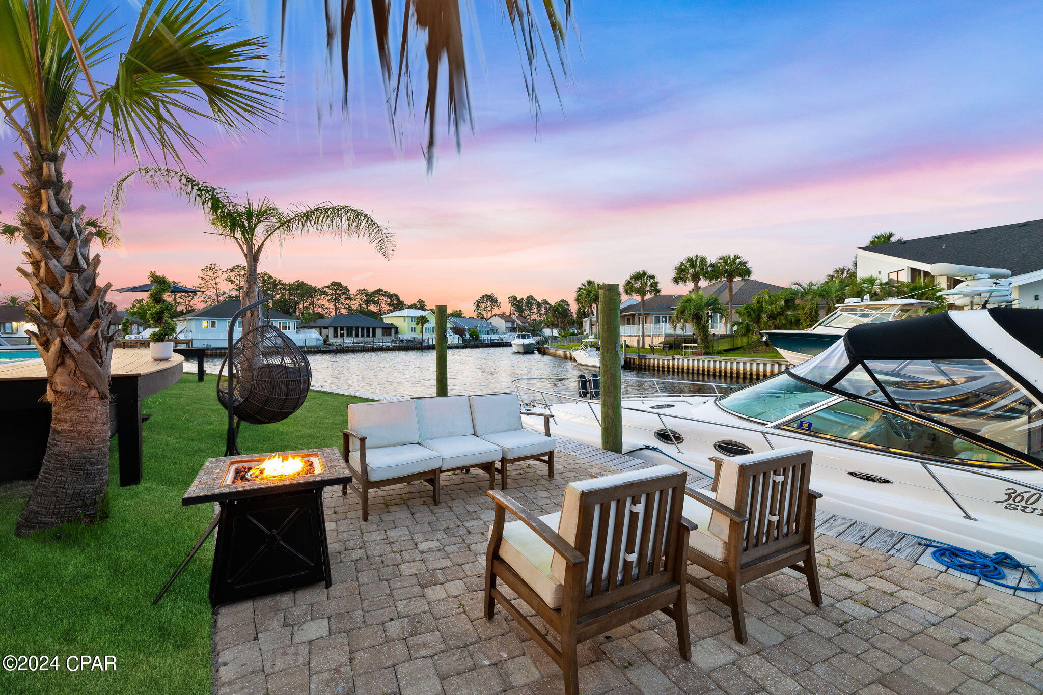 FULLY RENOVATED custom waterfront home with 155ft of frontage to accommodate all of your boating toys! Hop on your boat, and in just a short trip of a few miles, you'll find yourself at the crystal-clear waters of the Gulf of Mexico. As you step inside oversized French doors greet you into the foyer. Here you will find a white oak staircase and a custom-crafted cypress wine cellar with Moroccan hand-carved French doors. This seamless transition leads you into the living room, where a floor-to-ceiling marbled stucco fireplace becomes an inviting focal point. The living room features cypress beams that traverse the ceiling and a 4-panel glass sliding door, connecting the indoors with the outdoor space. Continuing through the home, you'll find the formal dining room and kitchen. In the kitchen, you'll find full-height hardwood cabinets with roll-out drawers, a spice rack, and a garbage bin, along with a 40'' Wolf gas range featuring a 24'' flat top, four burners and a double oven. Above the range, there's a Wolf ventilation hood, all complemented by a Sub-Zero refrigerator. The kitchen's focal point is a 12-foot island featuring a mint quartz countertop with an integrated butcher block cutting board. A Sharp microwave drawer adds modern convenience. As you continue through the hall, you'll find one of two laundry areas. The half bath showcases wood cabinetry and a quartz slab backsplash. Upon entering the master bedroom, you'll immediately notice the whitewashed cypress beams and a marbled stucco fireplace, which is fully remote-controlled. The master closet, generously sized at 17X15ft, features custom cabinetry, an island with a quartz waterfall edge countertop and a spot for a Laundry Center. The master bathroom exudes a spa-like ambiance with Dolomite Carrara marble shower walls that span the width of the room, featuring separate his and her showers, with a soaking tub as the centerpiece. You'll also find a Dolomite Carrara marble backsplash, coastal blue wood cabinetry, a trough sink, vaulted ceilings with natural cypress beams and pebble-blue mosaic tile that seamlessly flows throughout. As you go upstairs, you'll find the first bedroom and a jack-and-jill bathroom connecting it to the second bedroom, offering a beautiful water view. Each room has its own granite vanity, with a shared shower area in-between. The spacious bonus room is perfect for entertainment, teens, or a home gym, with an elegant shell accent wall. The last bedroom is an ensuite with a walk-in closet and a bathroom featuring a tiled shower, double vanity with wood cabinets, granite countertop, and a linen closet. There's also a storage room and ample attic space. In the yard, Florida palms add to the coastal charm. A sliding door opens to an 18'X36' saltwater heated pool, recently resurfaced with a 10'X13' swim platform, coastal blue tiles, and deck jets. New pool equipment includes a variable-speed 1.5HP pool pump and Styrite pool heater. Pavers guide you to the boat dock for sunset cruises. Lastly, there's a 6 Person Hot Tub by spa. Nestled within Bay Point's private gated community, this home is surrounded by a world of top-tier amenities, including 24-hour security. Here, you will find the Nicklaus Golf Course, a soothing spa, Point South Marina - a new full-service marina and yacht club, a community post office and beachside restaurants and bars. See list of upgrades below: 

Upgrades/Features: Exterior NEW- 
-Hurricane impact windows, doors & 4 panel Glass slider
-Removed existing stucco down to sheathing, replaced sheathing as needed and installed new tyvek, entire home was covered in concrete board and synthetic stucco applied to concrete board with slick finish. Repainted with elastomeric paint.
-New Exterior subpanel
-New 16-foot sheet pile seawall
-Resurfaced 18x36-foot Saltwater Heated Pool with the addition of a Swim Platform, Tiles and Deck Jets & Water Features..... -6-Person 48 Jet Hot Tub/Spa w/Bluetooth
-New Variable-Speed 1.5HP Pool Pump and Styrite Pool Heater.
-Entire back deck has been reframed with new lumber and deck boards
-50amp service for shore power pedestal
-Front and back sprinkler system along with bubblers for the landscaping. Fully Relandscaped with new Palms
-Paver driveway and backyard pavers
-Roof replaced 2019
-Two 5 Ton Goodman AC Units (replaced 2019)
-Exterior Lighting
-Wired for TV & Speakers

INTERIOR
NEW
-Marbled Stucco Fireplace, remote controlled in Livingroom (Ventless) and master bedroom
-LVP Flooring throughout (Tile in bathrooms & Broadloom Carpet MSTR Closet)
-New Interior Trim
-Canlite LED trims with the capability to adjust the color temperature (Kelvin settings)
-Washer/Dryer Hookup in Closet with LG 27'' Laundry Center & LG Styler Steam Closet
-New 80 gallon light commercial grade hot water heater with recirculating pump
-Added Bonus Room 2nd Floor
-White Washed and Raw Cypress Beams
-Custom Built Cypress Wine Cellar
-Wine Cellar Hand Carved Moroccan French Doors
-White Oak Stair Case with new Balusters
-Subzero Refrigerator
-48" Wolf Range with Flat Top, 4 Burners & Double Oven
-Wolf Ventilation Hood
-Sharp Microwave Drawer
-2nd Laundry Space Features Electrolux washer & Dryer
-17X15ft Master Closet w/quartz waterfall edge Island and custom Cabinetry.
- MSTR BA - Dolomite Carrara marble Shower. Soaking Tub. Dolomite Carrara marble backsplash, Blue Glass Pebble Flooring, Cypress Beams.
-MSTR BA Hardwood Cabinets with Quartz Countertops
-Wood Cabinets in Bathrooms with granite Countertops (2nd Floor)
-Hardwood Kitchen cabinetry is full height and includes pull out shelves, a spice rack, garbage bin, and Sharp microwave drawer/ 12ft Island w/Quartz Countertop & Accent Stump
-New Chandeliers throughout
-Upstairs Bathrooms Refinished with Tile Showers w/glass
-Repainted and existing walls sanded &/or new sheetrock installed where gutted or reframed windows. New insulation prior to new sheetrock in places that were gutted.
& More!! Call/Text for more information or to schedule a time to view this beautiful home!
