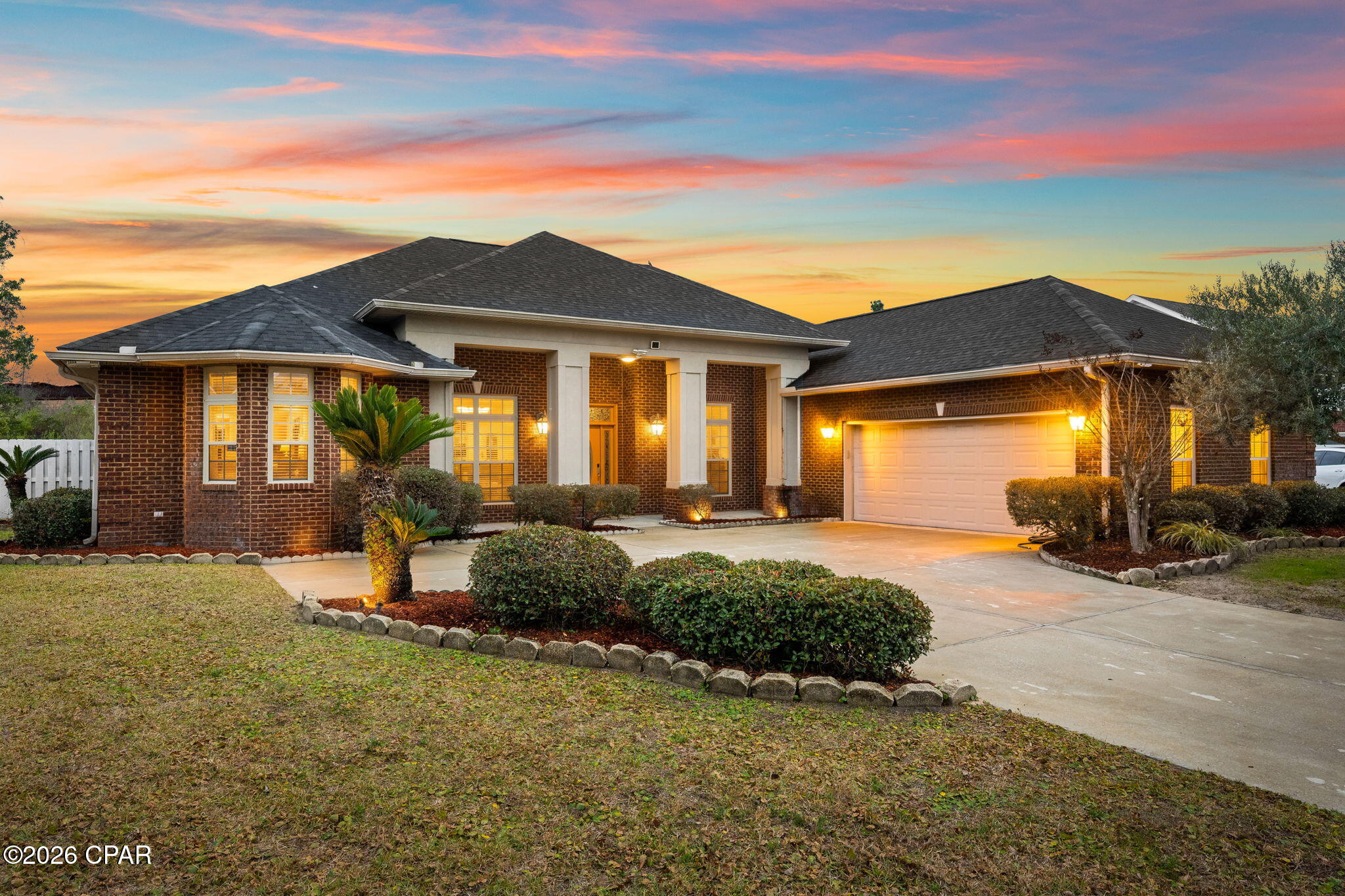 Custom-built all-brick home showcasing timeless architectural and designer details, located in the highly desirable Woodrun community. This well-maintained neighborhood offers sidewalks, curbs, and convenient access to the Highway 77 corridor, shopping, dining, and entertainment.

From the moment you arrive, you'll notice the artistic etched glass front door and transoms, designed and signed by artist Patrick Reynolds, creating a striking and memorable entrance. Inside, the split floor plan offers both privacy and functionality, with an open-concept layout ideal for everyday living and entertaining.

The kitchen is thoughtfully designed with custom mahogany cabinetry, granite countertops, gas cooktop with designer hood, under-cabinet lighting, ample storage, and a breakfast bar that opens to the main living areas. Ten-foot ceilings throughout enhance the home's spacious feel. Floor outlets in both the formal living room and great room allow for flexible furniture placement and interior design options.

The primary suite features a tray ceiling and a spa-inspired ensuite with a soaking tub, separate shower, and dual walk-in closets. A dedicated office provides flexible space for work, guests, or hobbies. A well-appointed half bath is conveniently located near the formal living area for guests.

Recent improvements include a tankless water heater (2024), furnace (2024), Dishwasher (2024), and a roof replaced in 2019, offering added peace of mind. The washer and dryer will convey with the home for added convenience.

The great room is highlighted by an electric fireplace, creating a warm and inviting focal point. Multiple rooms open to the screened-in rear patio, offering a seamless indoor-outdoor living experience. The private, fully fenced backyard includes a brick grilling area with pergola: ideal for relaxing or entertaining in Florida's coastal climate.

This thoughtfully designed home combines quality craftsmanship, functional layout, and classic style in a sought-after location.