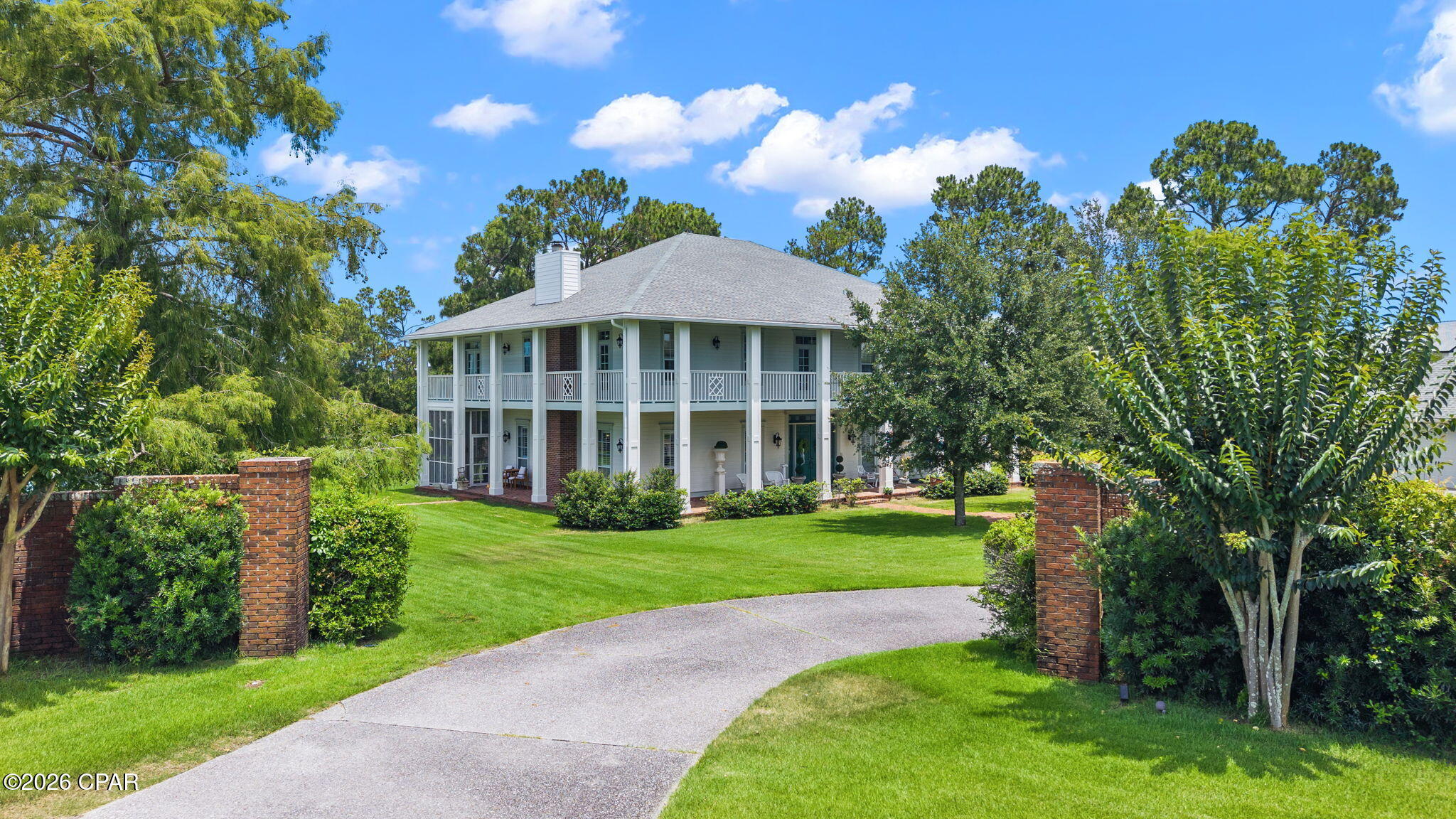 Tucked behind the gates of Bay Point, a grand Southern, Colonial plantation-style estate set on nearly an acre of manicured grounds has been designed for families to enjoy for generations to come. A stunning, two and a half homesites in total overlooking the 6th green, this home truly impresses!

At almost 4.700 square feet and sitting on one of the largest homesites in the community, you'll enjoy .87 acres overlooking a tranquil pond and private pool. A showstopper of acreage, views and privacy, this is a property that earns its reputation before you ever step through the door. The full-width, wrap-around porches and balconies spanning both levels set the tone immediately: this is a home built for living and blends the indoors and outdoors seamlessly.

Step through the grand foyer and you'll see a thoughtful design with attention to family gatherings. To the right, a private home office with a full bath and direct access to the wrap-around patio, perfect for the executive who needs a true separation between work and home, or for guests who deserve their own wing. To the left, an extraordinary living room anchors the main level entertaining experience: a room large enough for pool, ping pong and more, including a wet bar and a fireplace, soaring high ceilings, and the energy of a space that has seen it's share of neighborhood family parties! This is the room that becomes part of your family's legend.

A wine room positioned across from the formal dining room speaks to the home's commitment to entertaining done properly. The kitchen has been fully renovated and nothing short of spectacular. A built-in banquette for relaxed morning breakfasts. A dedicated coffee bar. A large island with waterfall countertops. Custom cabinetry, stainless appliances, and a layout that opens directly to a cozy living area and a screened porch, keeping the cook in your family connected to the conversation. Every detail here was considered!

Step off the screened porch and into a backyard that redefines what outdoor living at the beach looks like. The pool and spa are stunning. They're built for long summer afternoons and evenings that never seem to end. Beyond the 40' pool, nearly an acre of lush, private lawn opens up into something rare in any gated community: space. Room for pickleball, bocce ball, basketball, batting practice, or whatever your family dreams up. And at the edge of it all, your own private dock on the pond overlooking the golf course.

Upstairs, the primary suite is a true sanctuary. Spacious, serene, and anchored by a fully appointed en-suite bath with a soaking tub, a tiled walk-in shower, and double vanities. Step through to the full-width wrap-around balcony, your own private morning retreat with coffee in hand and nothing but pond and golf course views of Bay Point. Each of the remaining bedrooms offers its own en-suite bath, giving every member of the household the kind of privacy that keeps families at peace. A flex room at the top of the stairs rounds out the upper level, equally suited as a fitness room, a playroom, a study, or whatever the next chapter of your life requires. 

This home has been well-maintained and recently had the exterior completely repainted and is stunning from the moment you drive in the gates. Living at Legend Lakes means living inside one of the most coveted communities on the Gulf Coast. Bay Point is golf-cart friendly, gated, and layered with amenities that make every day feel like a vacation you never have to leave. Point South Marina. The Bay Point Golf Club. Neon's Bar 72. The Serenity full-service spa...all on site. And when the beach calls, you are ten minutes from some of the most beautiful white sand and turquoise waters on the Florida Panhandle. Keep your boat at the Point South Marina and never get in your car to hit the water - just a short 2 minute golf cart ride to your vessel! 

This is the home where your family builds its memories and legends begin.