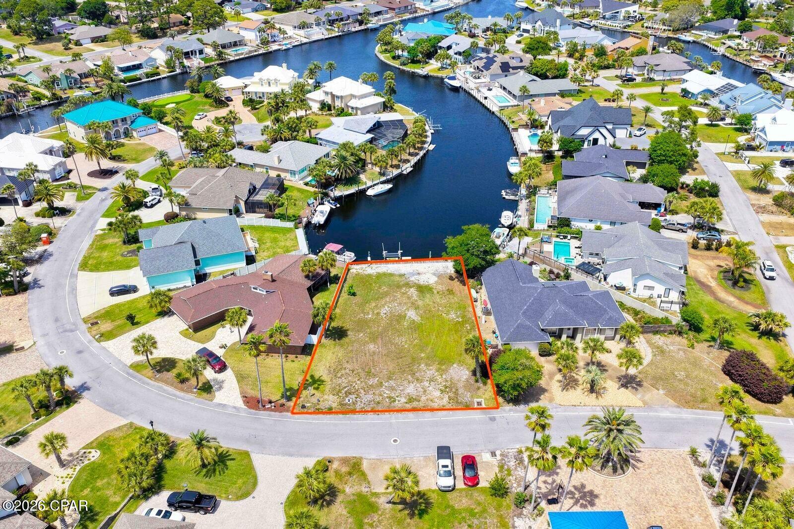Build your dream waterfront home and keep your boat right in your backyard! This is one of the few remaining deep-water canal homesites available in the  gated community of Bay Point. Ready for construction, the property is already equipped with water, power, and a boat lift, saving valuable time and significant development costs. An added bonus is its ideal positioning, offering long, picturesque views down the canal rather than directly across, creating a more open and impressive waterfront setting. House plans are available, making it even easier to bring your vision to life. Enjoy direct deep-water access from your dock to the Gulf, whether you're heading out for a day of fishing, cruising to Shell Island, or simply enjoying life on the water. Bay Point is one of Panama City Beach's premier gated communities, featuring 24-hour security, a Jack Nicklaus championship golf course, a full-service marina, on-site dining, and beautifully maintained grounds. Conveniently located just minutes from St. Andrews State Park, Shell Island, shopping, restaurants, and the sugar-white beaches of the Gulf Coast. Rare opportunities like this don't come along often. Build exactly what you've been dreaming of in one of the area's most desirable waterfront communities. Seller is a Florida licensed real estate agent.
