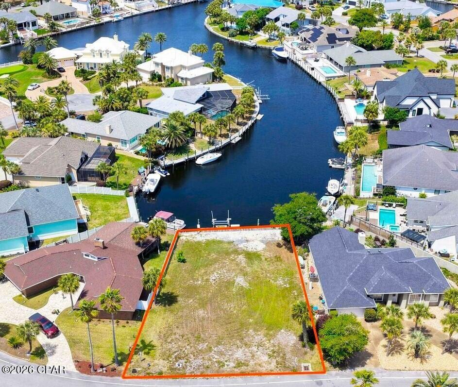 Dock your boat right behind your home! One of the few remaining deep-water canal lots in Bay Point 
now available, an exceptional opportunity to build your dream waterfront home! This homesite is already equipped with water, power, and a boat lift, saving you time and significant upfront costs. Even better, the lot is perfectly positioned to look down the canal rather than across, offering long, stunning water views that truly sets it apart. House plans available, making it easy to start bringing your vision to life right away. Enjoy direct boating access from your backyard all the way to the Gulf for a day of fishing or cruising to Shell Island for a day of fun! Located in one of the area's most sought-after gated communities, Bay Point offers 24-hour security, a championship golf course, a full-service marina, on-site dining, and more. Just minutes from St. Andrews State Park, Shell Island, shopping, dining, and the beautiful white-sand beaches. This is a rare chance to own a ready-to-build waterfront lot in a premier location--don't miss it! Call today to schedule your private showing! Seller is Fl Real Estate Agent.