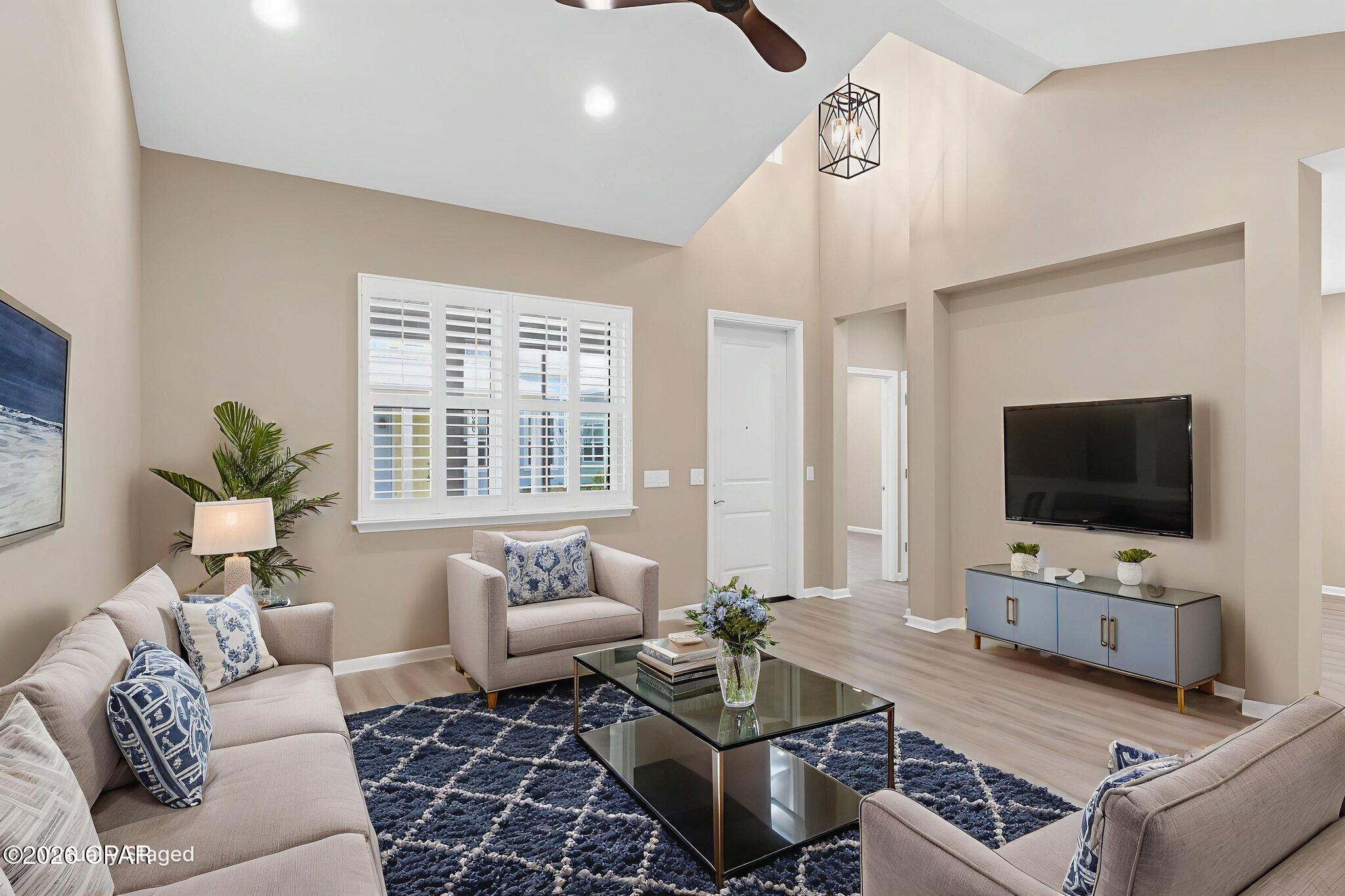 Welcome to your coastal retreat in Latitude Margaritaville Watersound!

This beautifully upgraded Camellia Cottage, located in sought-after close-in Phase 4, offers the perfect blend of style, comfort, and low-maintenance living just minutes from all of the community's world-class amenities.

The open-concept floorplan is light and bright, featuring a cathedral ceiling in the great room, Revwood by Mohawk laminate flooring throughout the main living areas, and designer recessed and statement lighting in the kitchen. The gourmet kitchen is a standout with extended quartz island, upgraded burlap-colored cabinetry, and sleek quartz countertops—ideal for entertaining or everyday living.

The bedrooms are finished with plush carpeting, while baths feature tile flooring for a clean, coastal look. Enjoy outdoor living year-round from the screened porch, perfect for morning coffee or evening relaxation. Plantation shutters throughout. The spacious laundry room includes washer and dryer, plus cabinets to the ceiling for added storage.

The garage is equally impressive with epoxy floors, utility sink, and built-in cabinetry, making it perfect for a workshop or additional storage.

Additional highlights include:
Washer & dryer included,10-year structural warranty from original build date.


Cottage HOA dues include exterior maintenance, including roof replacement and exterior paint on a scheduled program, providing true lock-and-leave convenience.

As a resident of Latitude Margaritaville Watersound, you'll enjoy resort-style amenities including a state-of-the-art fitness center, indoor & outdoor pools, pickleball and tennis courts, walking trails, live entertainment, restaurants, clubs, and a vibrant social calendar—all just 7 miles from the sugar-white beaches of the Emerald Coast.

A new commercial area adjacent to the community will feature a Publix grocery store, shopping, dining, and more, and a brand-new hospital is currently being built just 5 miles away, adding even more convenience.

Come experience why so many choose to live the Latitude lifestyle—this Camellia Cottage is truly move-in ready and a must-see!