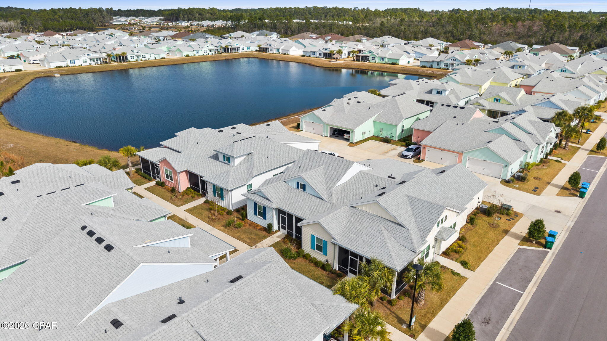 Welcome to your coastal retreat in Latitude Margaritaville Watersound!

This beautifully upgraded Camellia Cottage, located in sought-after close-in Phase 4, offers the perfect blend of style, comfort, and low-maintenance living just minutes from all of the community's world-class amenities.

The open-concept floorplan is light and bright, featuring a cathedral ceiling in the great room, Revwood by Mohawk laminate flooring throughout the main living areas, and designer recessed and statement lighting in the kitchen. The gourmet kitchen is a standout with extended quartz island, upgraded burlap-colored cabinetry, and sleek quartz countertops—ideal for entertaining or everyday living.

The bedrooms are finished with plush carpeting, while baths feature tile flooring for a clean, coastal look. Enjoy outdoor living year-round from the screened porch, perfect for morning coffee or evening relaxation. Plantation shutters throughout. The spacious laundry room includes washer and dryer, plus cabinets to the ceiling for added storage.

The garage is equally impressive with epoxy floors, utility sink, and built-in cabinetry, making it perfect for a workshop or additional storage.

Additional highlights include:
Washer & dryer included,10-year structural warranty from original build date.


Cottage HOA dues include exterior maintenance, including roof replacement and exterior paint on a scheduled program, providing true lock-and-leave convenience.

As a resident of Latitude Margaritaville Watersound, you'll enjoy resort-style amenities including a state-of-the-art fitness center, indoor & outdoor pools, pickleball and tennis courts, walking trails, live entertainment, restaurants, clubs, and a vibrant social calendar—all just 7 miles from the sugar-white beaches of the Emerald Coast.

A new commercial area adjacent to the community will feature a Publix grocery store, shopping, dining, and more, and a brand-new hospital is currently being built just 5 miles away, adding even more convenience.

Come experience why so many choose to live the Latitude lifestyle—this Camellia Cottage is truly move-in ready and a must-see!