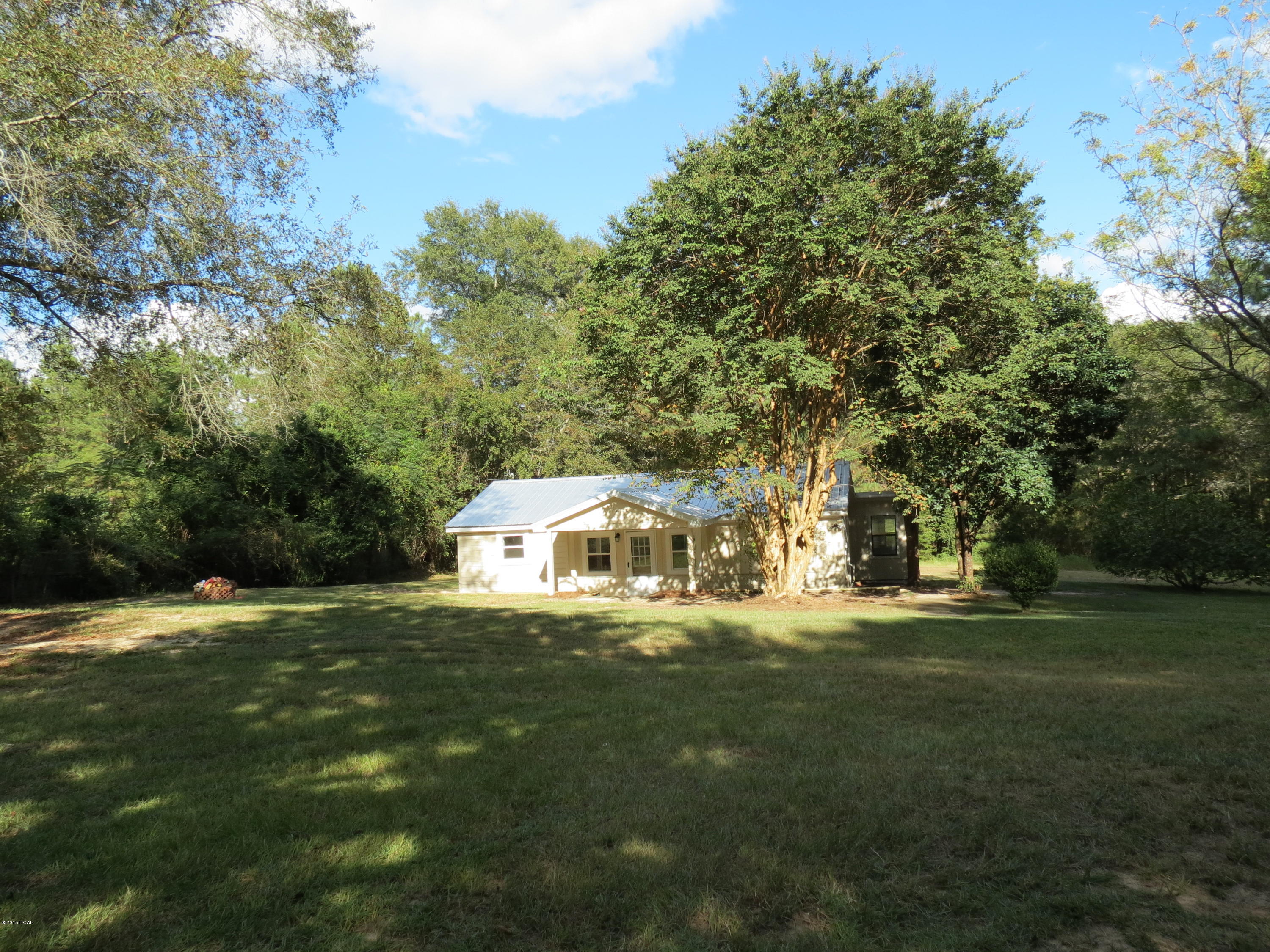 Selling due to illness in the family.  No Traffic!!!  Just a few hundred feet off a paved road and only 4 miles to Marianna!  Home for the Holidays!  Just 30 min. to Dothan, AL - 60 min. to Panama City, FL - and 90 min. to Tallahassee.  Home is newly cleaned and painted inside and outside + improvements.  Handsome NEW metal roof, See nice oak kitchen and bath cabinets, Ceramic tile throughout the entire home, Central heat and air, well and septic.  Truly a bargain and a nice place to raise a family or enjoy your pets.  2 additional acres available.  All sizes may not be exact and if important to you, PLEASE MEASURE.  OWNER IS A REALTOR LICENSED BY THE STATE OF FLORIDA.