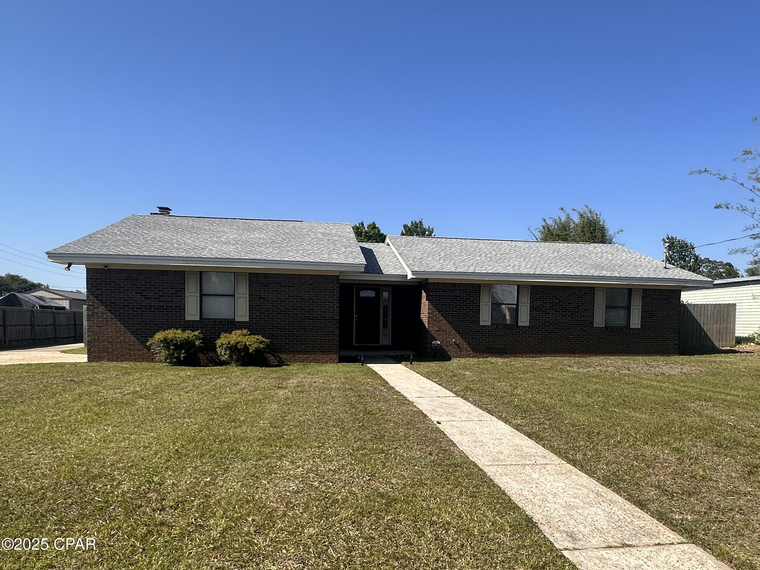 Adorable 3-bedroom 2 bath move-in ready home! Located minutes from shopping, restaurants, Navy base, Tyndall AFB and the world's most beautiful beaches. Freshly painted and new built-in oven. Vinyl plank flooring throughout home except master bath which has been beautifully updated with extra-large walk-in shower. Master has large walk-in closet with 2 additional bedrooms w/ large closets. Living area w/fireplace. Partially fenced large back yard. One car garage and also lots of extra parking in driveway w/ extra parking pads. Active-Duty Military 1/2 Off Security Deposit! Pet-friendly with pet fee.
