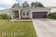 Located in one of Lynn Haven's most desirable subdivisions - The Hammocks! This beautifully tiled home is just 2 doors down from the community pool! It features 3 bedrooms/2 baths, upgraded kitchen cabinetry, a built-in home office area, and a large cleared backyard. The impressive living room is bright and open with vaulted ceiling. There is a formal dining room, eat-in kitchen, and laundry room (not closet but actual room). The master bedroom and en suite is spacious and opens up to the patio and backyard. This home is zoned for some of the best schools Hiland Park Elementary, Mowat Middle, and Mosley High school (walking distance) and is just minutes from the highly sought after Bay Haven Charter Acad (walking distance).
