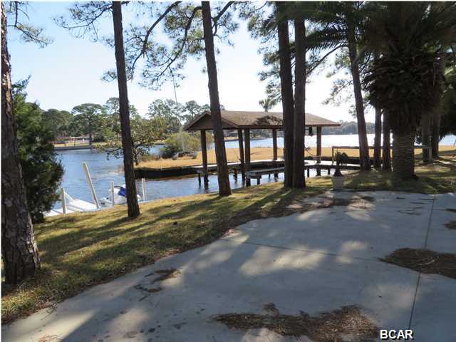 Waterfront home on St. Andrew Bay. This one of a kind 6,640 sq. ft. home has WATER on 3 sides. A beautiful bay view and a snug harbor for your boat. This custom built home speaks of quality and craftsmanship. The master bedroom has a large wrap around balcony, a separate reading parlor and a view of the bay and bayou. The large master bath has a separate shower and two large walk-in closets. The other three spacious bedrooms have their own balcony and bath. The large great room has an unbelievable water view to enjoy the sunsets and watch the dolphins. Some of the extras include a custom bar, elevator, workshop, instant hotwater heater, central vacumn cleaner, outside shower and large wrap around porch. This home was built for entertaining.