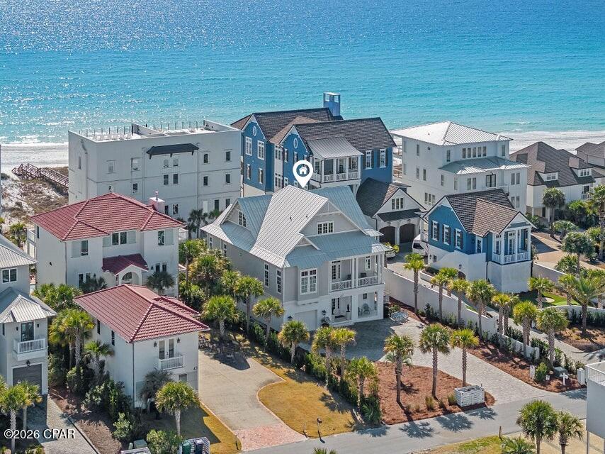 Perched along the highly coveted San Roy Road in the heart of Seagrove Beach, 67 San Roy Road presents an extraordinary opportunity to own a luxury coastal retreat with breathtaking views of the Gulf of Mexico and Eastern Lake. Perfectly positioned to capture both water vistas and the essence of 30A living, this remarkable residence offers effortless access to sugar-white sands, emerald waters, coastal dune lakes, renowned dining, boutique shopping, and world-class boating and fishing. Thoughtfully designed with architectural distinction and refined finishes throughout, this estate features six spacious bedrooms, six full bathrooms, and one half bath, complemented by multiple indoor and outdoor living areas ideal for both entertaining and beach therapy.

The property includes a private garage, generous additional parking, a residential elevator servicing all levels, and a stunning private pool with expansive outdoor entertaining space. The homesite also offers room for a future carriage house or guest quarters, enhancing long-term flexibility and value.

The first level welcomes guests through a grand entry foyer into a spacious secondary living area complete with a wet bar and direct access to outdoor gathering spaces. Two king suites, a custom bunk room with dedicated bath, a large laundry room, and garage access are thoughtfully situated on this level, creating a private retreat for guests and family. The second floor serves as the heart of the home, anchored by an impressive great room designed for seamless coastal living. The chef's kitchen showcases an oversized island, premium appliances, custom cabinetry, and designer finishes, flowing effortlessly into generous dining and living spaces one accented by a gas fireplace. Two additional king suites occupy this level, each offering beautiful water views and private access to outdoor terraces. A powder room, walk-in closets, and an additional laundry area add convenience.

The entire third floor is dedicated to a luxurious primary suite sanctuary. Accessible via elevator or staircase, this private retreat features sweeping Gulf views, a sitting area with wet bar, spa-inspired bath with soaking tub and walk-in shower, expansive closet space, a private laundry area, and a versatile flex room ideal for an office or fitness studio. This level offers an unparalleled sense of privacy and sophistication rarely found along the coast.

Outdoor living reaches new heights on the second level, where a spectacular elevated pool anchors a sprawling terrace designed for entertaining. An outdoor kitchen, dining area, and ample lounge space create an exceptional setting for sunset gatherings with panoramic Gulf and lake views.

Whether envisioned as a primary residence, second home, or premier investment property, 67 San Roy Road delivers an unmatched lifestyle in one of 30A's most desirable locations. A rare blend of architecture, views, and income potential makes this Seagrove estate a true coastal masterpiece.