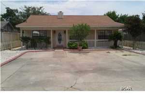 Great beach home in established neighborhood, close to Pier Park, shopping, movie theater and the worlds must beautiful beaches! This three bedroom two bath home is ready to go with new flooring, blinds,electrical switches and outlets, plus much more. Living room has a wood burning fireplace and tile flooring, all the bedrooms have wood laminate flooring for easy upkeep and double sinks in the master bath. Outside still needs a little TLC, however at this price it won't last long!