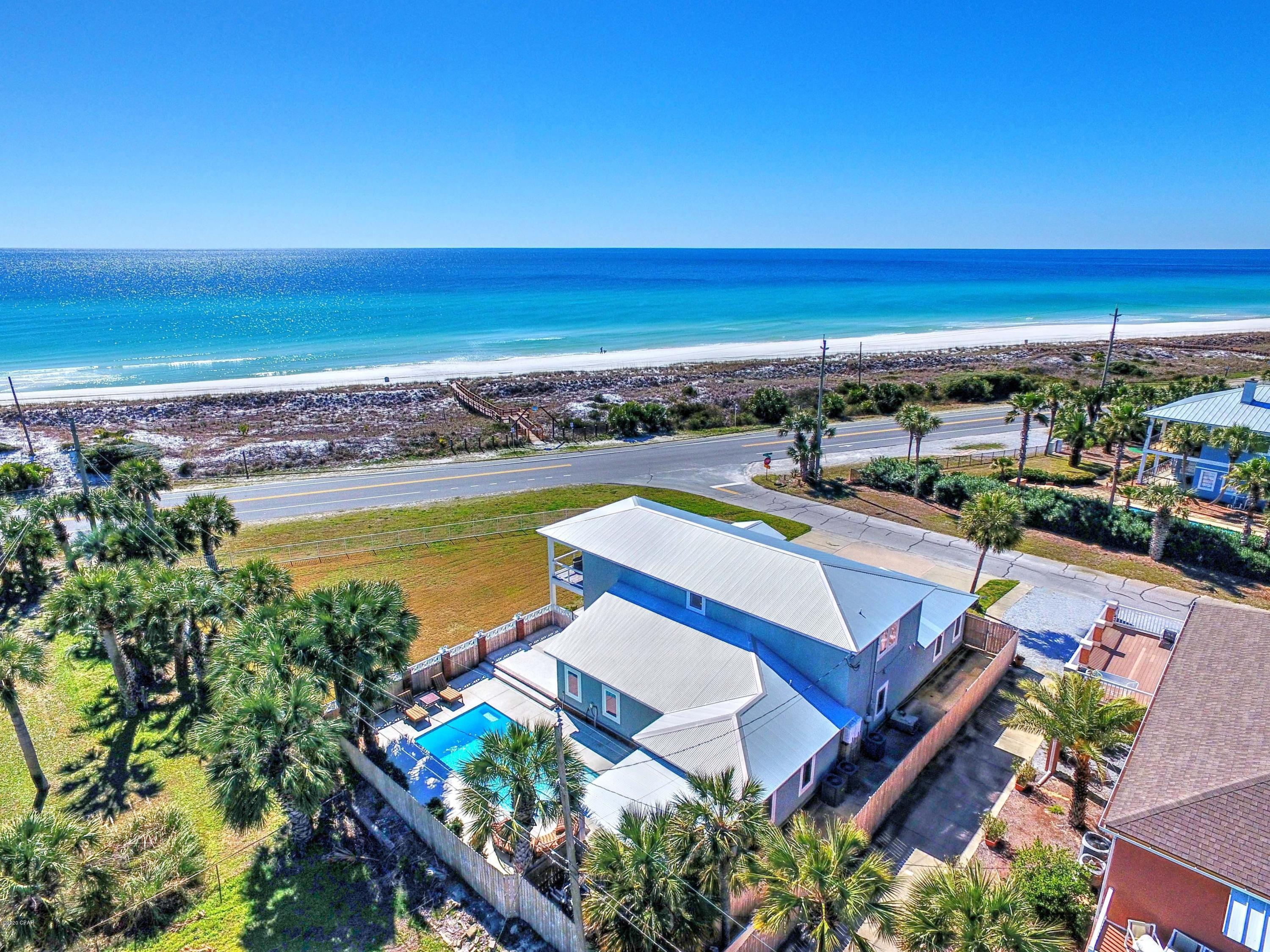 Exceptional investment opportunity! Located at the popular West end of Panama City Beach, this home is directly across the street from the private Santa Monica Beach and access.  It is perfectly positioned on an elevated, fenced, corner site to capture unobstructed, breathtaking, panoramic views of the Gulf. 

There is impressive outdoor living space with a large lawn that is perfect for wedding venues or family yard games, a large gas-heated pool surrounded by flickering lanterns, plenty of decking, two courtyards, a large covered porch, an outside bar, covered dining and grilling area.  The lot measures 127' in the front with room for a garage with carriage house, if desired. This Coastal Contemporary masterpiece spans over 3400 sq. ft. and sleeps 19! It was built from the ground up in 2015. The open floor plan accentuates this property's generous proportions and thoughtful design. As you enter the home you will be wowed by the raised ceiling and spaciousness of the main living/dining area. It is light and open with plenty of seating area, custom built entertainment center, and a wall of tall French glass doors showcasing the stunning Gulf views. 
All five over sized bedrooms and 4 1/2 baths are on the first level. The bunk room with 6 bunks measures 21' 10' x 10' 9.6"!
The open kitchen features tall cabinets, quartz counter tops, a 14' island bar, upgraded Stainless Steel appliances including a gas range, NG stove, and Samsung Hub WiFI Refrigerator.  The 2nd level loft area offers guests conversation and entertainment areas, a full bath and access to a large covered balcony for incredible sunsets and uncompromising Gulf and Western oriented views.
This prime location provides a quiet, and relaxing beach lifestyle while being just a short drive away from Scenic Hwy 30A with award winning restaurants, art galleries, entertainment and 20 miles of biking and jogging trails. In addition, Pier Park is five minutes away with hundreds of shops, dining, movie theater and entertainment.   This is an ideal rental retreat located on one 
of the largest sites on Front Beach Rd. It is currently on a short-term rental program. With the private beach just a short stroll from the front door, plenty of parking and room for 19 guests, this is an investment opportunity you won't want to miss!