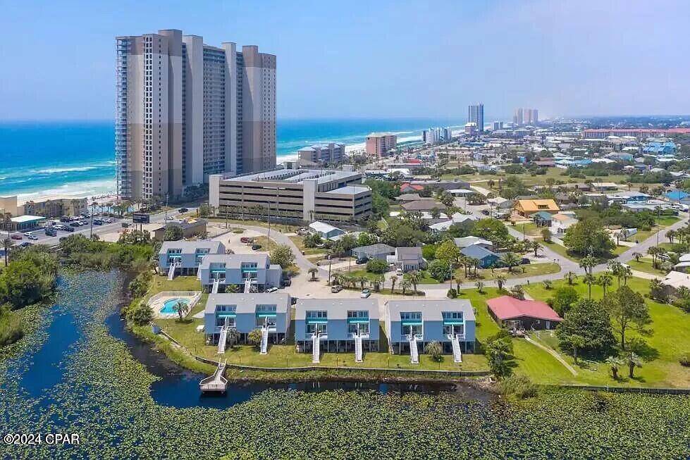 *$30k Price Improvement!!* LOWEST PRICED townhome available in Lullwater Beach!! Low density lake-front community located directly across from ''The World's Most Beautiful Beaches''. Full 2bd/2bth unit with amazing sunrise view! Turn-Key. Fully furnished and ready for your Retirment/Vacation/Rental needs. Walk to dining and entertainment and everything that Pier Park has to offer!  Lake with fishing dock, community pool and shuffleboard. Interior: Updates include new tinted windows and door wall, paint, A/c condenser. Exterior: All buildings have NEW siding, roofs, decks, and steps. Owner pets allowed.