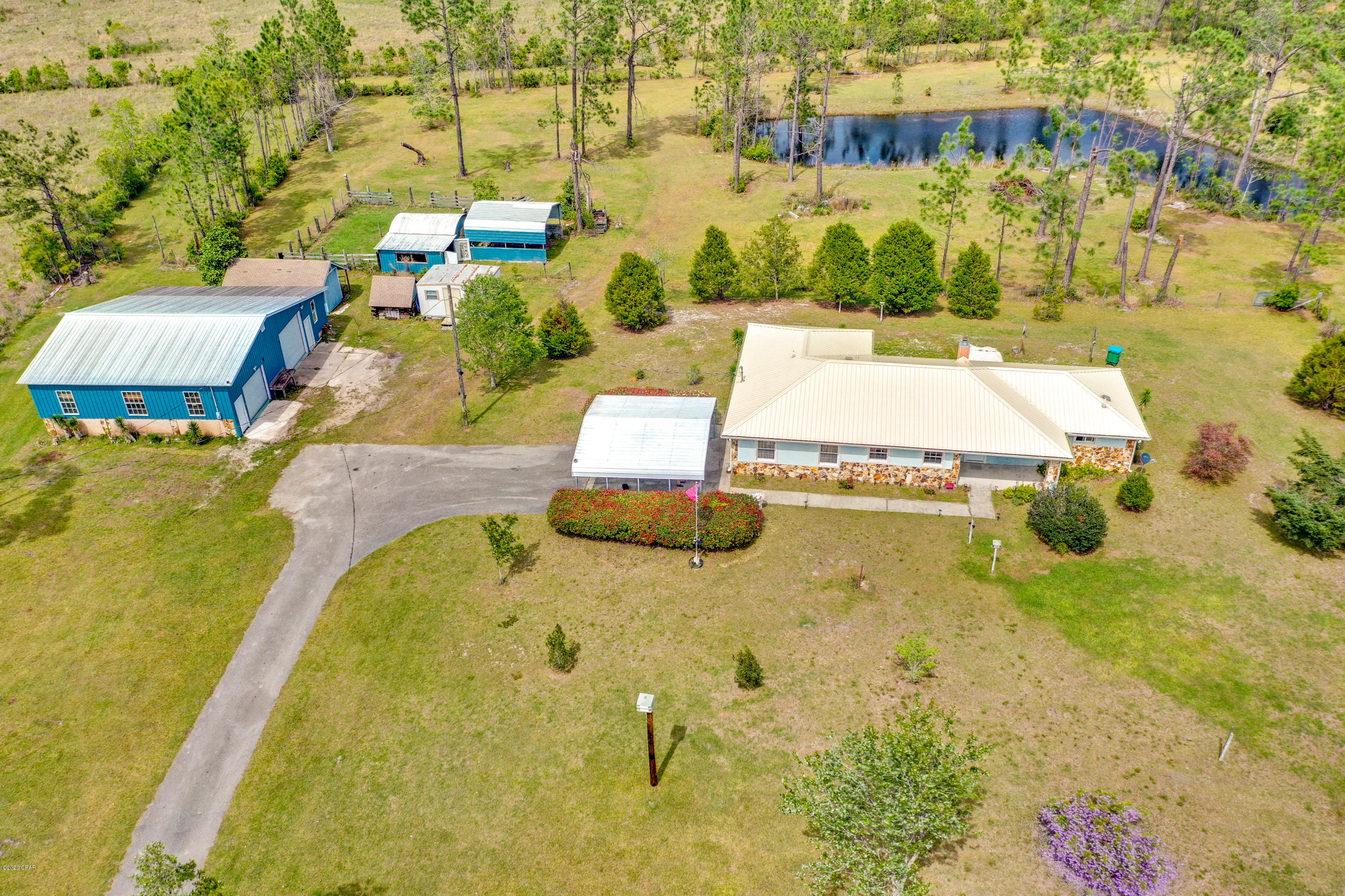 This is a multi offer situation. All offers with pof or prequal due by Friday at 2pm If you have been looking for a great home with lots of acreage for horses and multiple workshops you need to see this GREAT property. The home sits on about 8 acres and comes with an additional 1+ acre wooded lot across the street. The property has gorgeous pasture land with 2 spring fed ponds making it a GREAT spot for someone wiith horses, gardening, or fishing. The large pond is stocked with catfish. On the west side of the property there is a 36x48 Polebarn Workshop with a loft area and electricity that is perfect for anyone into wood working, mechanics, etc. There are 3 other smaller shops that could be used for storage or turned in to a hobby room/she shed. All shops are on a separate meter than the house. The property is completely fenced and cross fenced with gates and tons of beautiful trees and flowers like Knockout Roses, Confederate Jasmine, Night Blooming Jasmine, Pineapple plants, Crepe Myrtles, various Magnolia trees, Cypress Trees, Cedar Trees, Dogwood Trees, various Maple trees, Wysteria and more. The property alone will make you fall in love with the home. The metal roof was replaced in January of 2019 and there are precut, numbered hurricane boards for the windows of the home so you don't have to worry about the next hurricane. The interior of the home offers a GREAT open, split bedroom floor plan. There is a huge pantry giving you plenty or space for all your dishes, food, and overside small appliances. The living room features a wood burning stove, pine tongue and groove wainscoting, and a entertainment center made from pecky cypress. Both bedrooms are huge and offer huge walk in cedar closets. The master bedroom is plenty big enough for all your bedroom furniture as well as office furniture and has easy access to the large open back patio. The master bath has tons of cabinet space, a huge walk in shower and double vanity sinks. The A/C was replaced in November of 2019. Don't let the number of bedrooms scare you this home has tons of storage interior storage. The garage can easily be closed in to make for a 3rd bedroom and is already vented. There is so much that this great home has to offer that you really need to see it to appreciate it. Call your Realtor TODAY to see this great home.