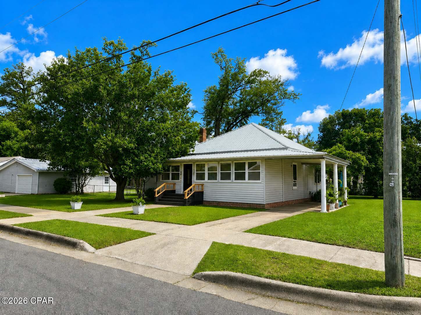 Welcome home to this beautifully updated corner-lot property that perfectly blends timeless character with modern farmhouse style. From the moment you arrive , you will notice the inviting curb appeal , mature shade trees , spacious yard and charming Southern appeal . 

Inside , the home offers warm hardwood floors throughout much of the living space ,  oversized rooms , soaring ceilings and a unique blend of rustic and contemporary finishes .  The main living room features a stunning deep teal accent wall, rich trim details and a cozy atmosphere ideal for entertaining or relaxing with the family .

The dining room is full of personality with custom lighting , dramatic dark accent walls and an easy flow into the kitchen and living room area . The dining room features a beautiful hutch that will stay with the home .

The kitchen features a beautiful rustic and colorful ceiling , a breakfast nook and a coffee bar that will stay with the home .  The refrigerator , gas stove , microwave and the gas dryer will also stay with the home .

The primary bedroom offers a warm lodge inspired feel with wood ceilings and rustic accents that create a relaxing retreat .

The other bedrooms are spacious and provide comfort and flexibility . One bedroom offers a private suite style room with its own private exterior entrance making it perfect for guests, multigenerational living and much more .

Step outside to enjoy the large screened entertainment porch complete with lighting , ceiling fans , grilling area and plenty of room for outdoor seating and game day gatherings .

This oversized corner lot also features a detached garage / man cave / she shed . The back side of this garage has a half bathroom and a tool shed or storage room . The double gates to the side of the shed allow access to the back yard .

There is currently an above ground pool . This pool can stay with the property if contracted soon, if not , it may be removed from the property .  The pool vac will not be included .

This property offers so much potential .  With proper approval , vision and some construction the garage could be converted into an apartment or mother n law suite .  

Must see to appreciate the full potential !!