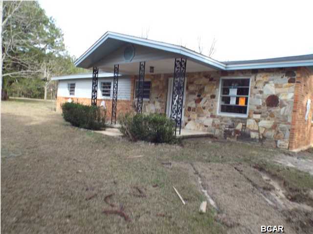 REDUCED!!! Large three bedroom two bathroom brick house with bonus room and road frontage on State Road 77 near Graceville offered as is. The property has a new roof and the inside has been white boxed. It is prepped for a new owners personal touches. All sizes approximate or taken from other sources please verify accordingly.