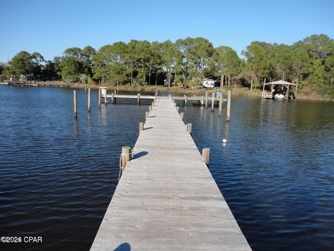 SELLER WILLING TO CONSIDER PAYING 6 MONTHS OF HOA UPFRONT FOR BUYER AT CLOSING! LOCATION LOCATION LOCATION Amenities at this community include:  Gated Community, Building has a elevator, Boat Dock and Boat Parking, Fish Station Cleaning, Pool, Tennis and Pickleball Court, Sauna, Picnic area with barbecue pits, tables and chairs, and Community Room. Enjoy coastal living in this well-maintained 1-bedroom, 1-bath unit in a highly desirable location just a block to the white sandy beach. This property offers a functional layout in good condition, perfect as a primary residence, second home, or investment opportunity. Just a short walk to the new tootsies, local restaurants, shops, and nearby activities, you'll love the convenience and lifestyle this location provides. Boating and fishing enthusiasts will appreciate the on-site dock with direct access to the beautiful emerald green water of the Gulf, making it easy to spend your days relaxing on the water. Don't miss your chance to own in this prime area with both relaxation and recreation right at your doorstep.  AC - 2021, Freshly Painted 2024, Furnishings 2024, Bathroom remolded 2024, Newer Kitchen Appliances 2024 (minus dishwasher) Come and See!!