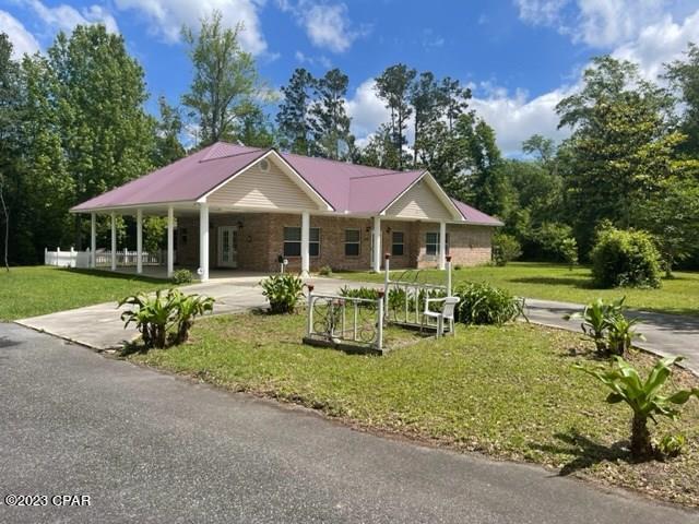 Turn key home that checks all the boxes for living in Gulf County without the coastal price tag.  This 3 bedroom, 2.5 bath home is situated on 2.6 acres of well manicured grounds with mature oaks, magnolias, and ornamentals as well as a large foliage buffer for privacy and size.  A paved driveway leads to covered carport for ease into the kitchen and dining area.  Kitchen is fully equipped with plenty of oak cabinets and countertop space as well as a built in pantry.  The dining area will accommodate a nice size table with plenty of seating options.  A decorative archway connects to a spacious great room that is accented with a tray ceiling, crown molding, floor molding, and two Hunter ceiling fans.  Great room has easy access to a front covered porch or a spacious screened-in porch via the laundry room/office area.  Off the great room are 3 bedrooms, 2 with En-Suites and one 1/2 bath.  The master bedroom is spacious with a large ceiling fan, wall to wall carpeting, crown molding and floor molding.  It has an En-Suite having a sunken jacuzzi tub as well as separate shower, closet, tile flooring, crown and base molding accents.  2nd bedroom has spacious full bath for additional privacy.  One of the best features of the property is a hobby and RV enthusiast's dream.  Adjacent to the house is a 20' x 50' concrete RV pad that is covered by a metal super structure.  Additionally, there is a large 40' x 26' enclosed garage that has a fully functional and equipped mother-in-law suite with a full bathroom and kitchen.  All of this and more only 5 minutes from two public boat launches and only 20 minutes +/- to Mexico Beach.  Take a moment and view the virtual tour.  Don't miss this truly well maintained and unique opportunity!  All dimensions were estimated by Gulf County PA Website, please verify if important.
