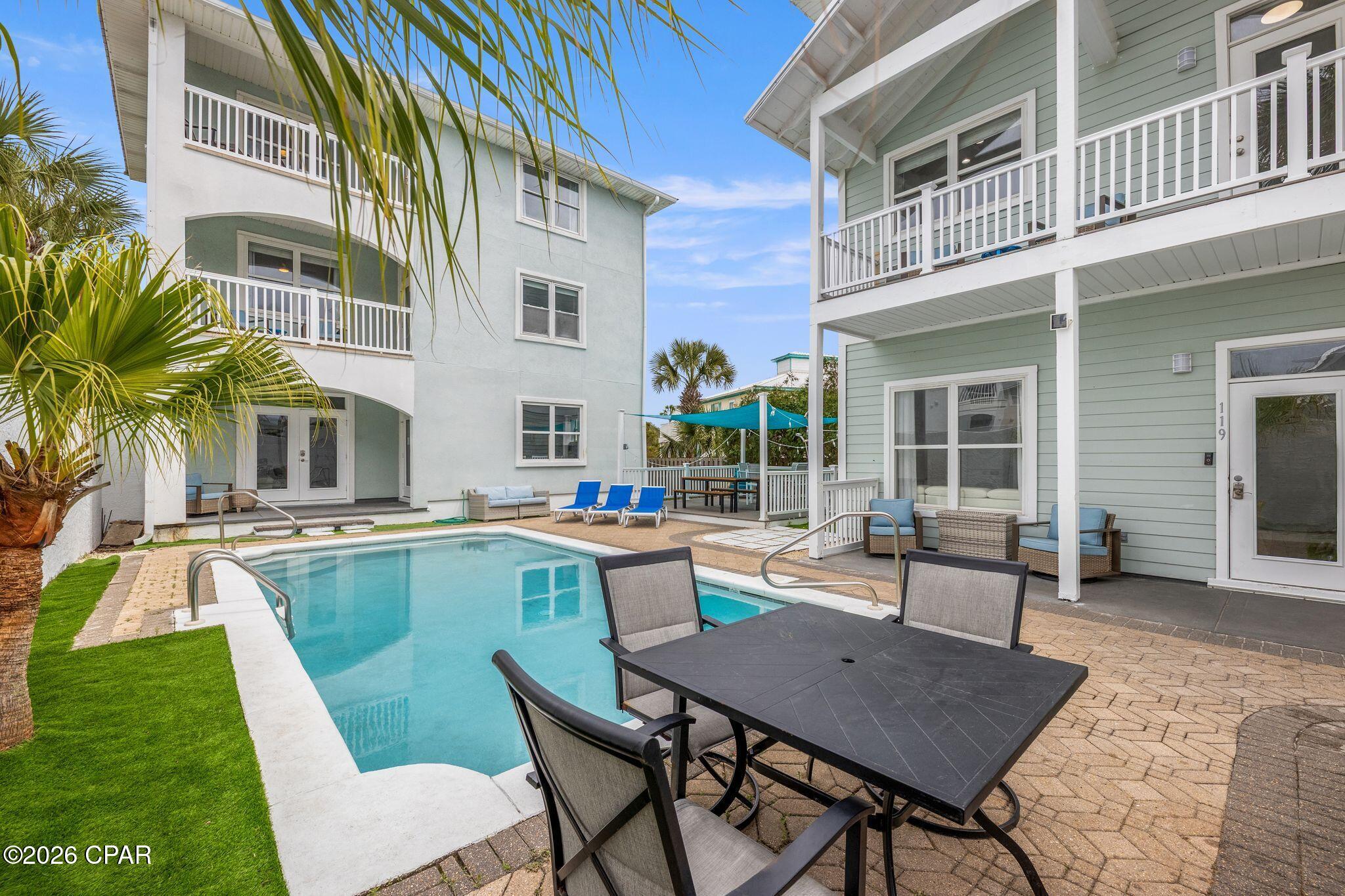 Exceptional investment opportunity on the west end of Panama City Beach, located just one block from Beach Access 93. This unique offering includes two separate three-story homes positioned in an estate-style layout, centered around a private pool and shared outdoor entertaining space.

The property is being sold as one parcel and includes a 1,818 sq ft home and a 2,046 sq ft home, totaling 3,864 sq ft under roof. Both homes are fully furnished and turnkey, with strong short-term rental history and consistent occupancy. Combined, the property comfortably accommodates over 22 guests, making it ideal for large groups and maximizing rental income potential. Actual rental figures available upon request.

Each home features updated bathrooms, modern fixtures, and multiple living areas designed for guest comfort. The second and third floors offer Gulf views with no obstructed sightlines, a rare feature for this proximity to the beach.

No HOA and short-term rentals are allowed, providing flexibility for both investors and personal use. The outdoor space is designed for entertaining, with ample room for grilling, gathering, and enjoying the private pool that separates the two residences.

Positioned on the desirable west end of PCB, this property offers easy access to the beach, dining, and local attractions while maintaining a more private, residential feel.