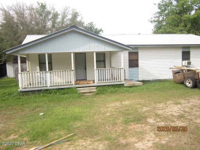 Frame on piers with vinyl siding on 1/3 acre lot, mostly privacy fenced.  House has front and rear porches.  Living/dining/kitchen is designed to be open area, but is presently unfinished and will need ceiling, flooring, painting and electrical work.  House features 3 bedrooms, and 2 baths.  The master suite is very large.  Cooling is by two window units.  The central HVAC unit is inoperable at present..  Two bedrooms have walk-in closets and one bedroom has no closet.  Outside is a yard building that features two rooms, one of which is finished inside (no bath) and a one car carport or equipment shed..  Master bedroom is 20 x 20, master bath is carpeted with garden tub and separate shower, double vanity, & linen closet.