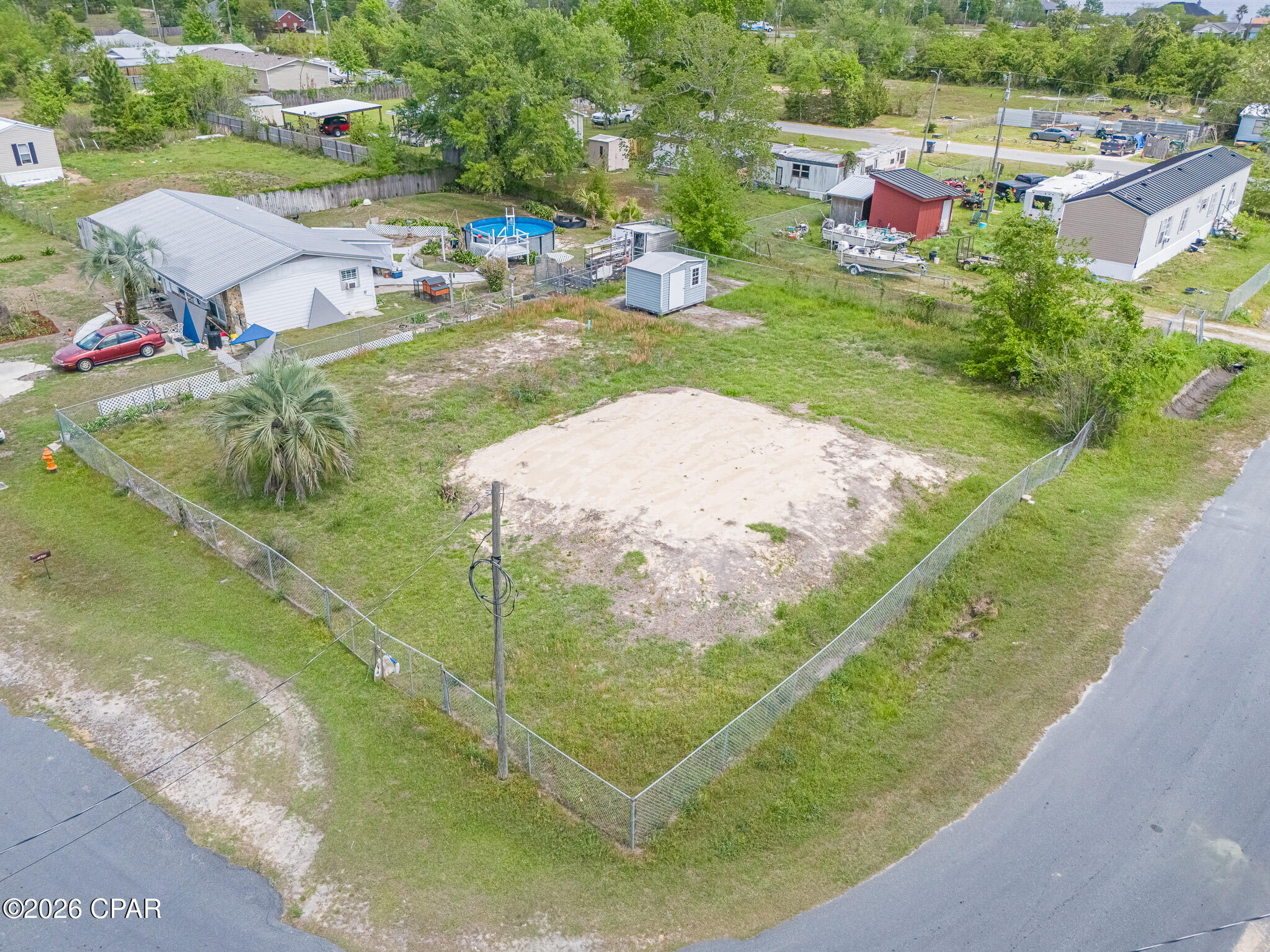 Level and well-prepared 1/4 acre Corner lot.  Brand new $17,000. fully permitted 1,050 gallon septic tank with drain fields that allow a home as large as 2,550 sq. ft.  Pad site prepped with enough fill dirt to not require a pump or have a mound appearance.  Chain link fenced with front entrance, double gate on the side and a dog run.  Concrete pad site for a shed also.  1 mile to Deer Point Draw Down Boat Ramp or North Bay Boat Ramp.
Single family homes, modular and manufactured homes are permitted.