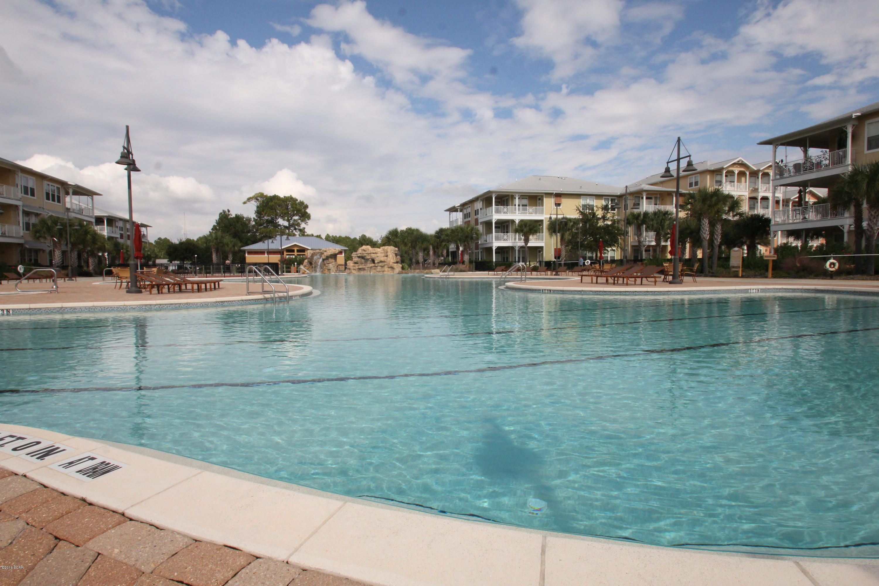 Great Rental Opportunity! If you haven’t been to Island Reserve recently then you are missing out on some amazing opportunities. Life at Island Reserve is similar to what you might expect from a 5 star resort. Island reserve is an oasis away from all the hustle and bustle of Panama City Beach, but in a prime location: just a little over a mile away from both the World’s Most Beautiful Beaches and the Hathaway Bridge. Island Reserve features low association dues and unbeatable amenities including the largest pool in the Bay County area (1 acre) w/ two waterfalls, a Splash Pad for the kids, numerous seating arrangements for your poolside entertaining, a heated and cooled indoor basketball court, fully stocked state of the art fitness room, a game room, a theater with an 80 inch screen, g community with security day and night. Plus, no short term rentals are allowed in Island Reserve so that means no Spring Break traffic at all! Mainly full time owners and residents throughout the entire complex. This is truly turning into one of the premiere residences in all of Bay County with a very well run association and friendly maintenance staff. Basically everything is taken care of when you live here at Island Reserve. This unit is on the 2nd floor in Building 4 just a few steps from the parking garage. It has a more private view located in the front of the complex and comes with a large balcony.  The unit has 2 Master Suites and each bedroom has a door to the large private patio. The rich Bamboo Floors and Granite Countertops throughout along with Stainless appliances make this luxury condominium hard to resist. There are elevators and stairs in each building. Covered Garage parking so you don't ever get wet coming in from the rain. Lowest priced Ground Floor unit in all of Island Reserve. This one won't last long at this price. Resort Living close to everything in Panama City Beach. Beach is 1.4 miles away or 3 minute drive from Island Reserve.