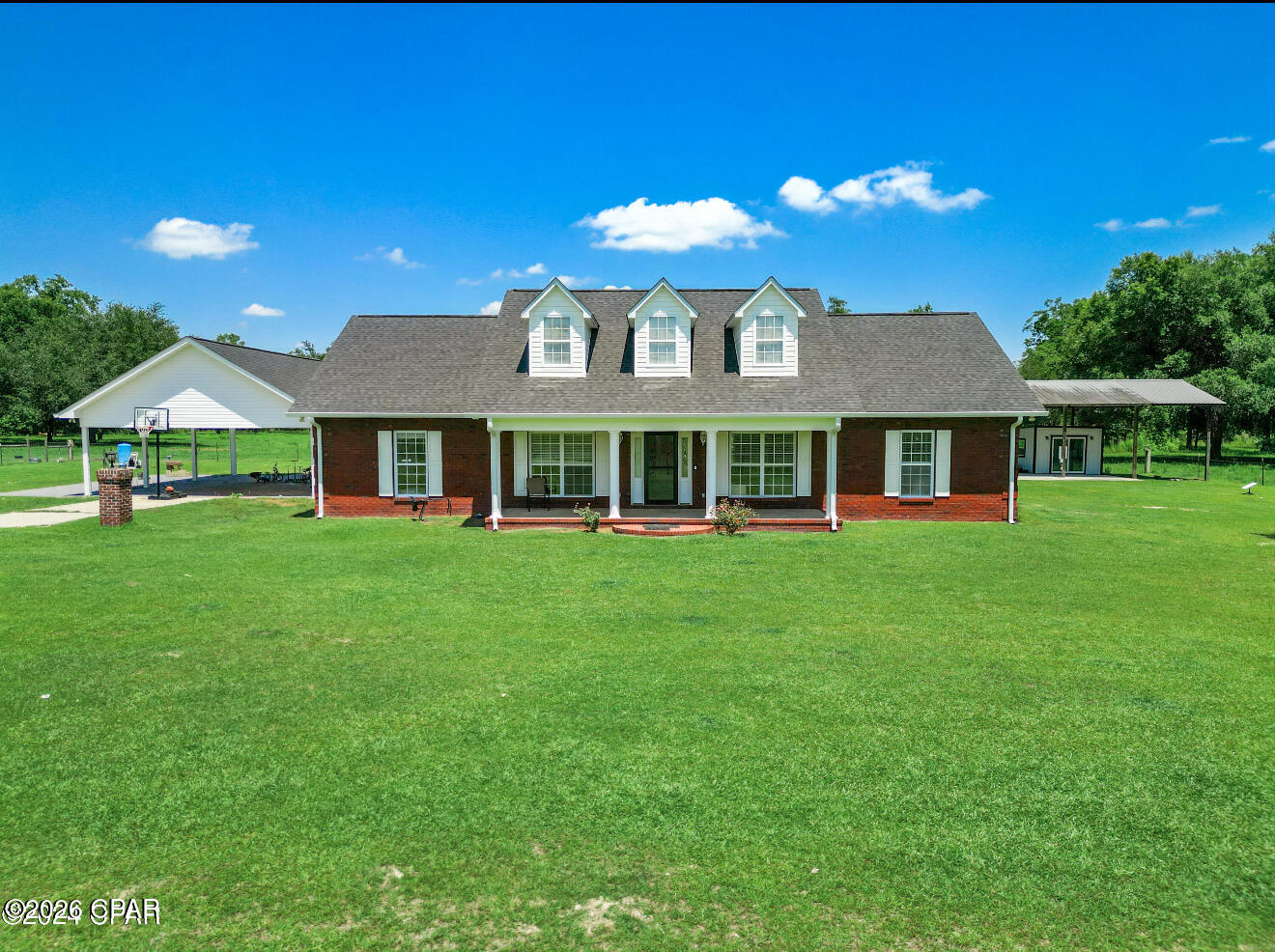 This one is a must-see because pictures simply can't do justice for this beautiful homestead in rural Jackson County Florida. The 20-acre fenced property affords plenty of space for a multitude of outdoor activities with ample room left for raising livestock. Three separate pole barns mean there are plenty of storage options for farm equipment, recreational vehicles, and anything else you'd like to protect from the elements. Two wells and two RV hook ups have been thoughtfully installed and one of the barns offers an enclosed 12x12 heated and cooled space that could serve as an office or a climate controlled storage unit. An in-ground pool is a great place to relax and cool off after a long day and there happens to be one of those on this property too! All of that and we haven't even talked about the almost 3 bedroom 2 full bath custom brick home that was built in 2008. The open concept vaulted ceiling living space invites visitors to cozy up by the gas fireplace and is flanked on one side by the master suite and the other by two bedrooms and a full bath. A 529 sq ft space off of the kitchen offers flexibility. Use it as a great room, a play room, a home gym, or a home school. This place is rural, but not remote. You can access shopping, schools, and parks in Marianna in about 20 minutes, world class fishing on Lake Seminole in about 15 minutes, or the emerald coast of Mexico Beach in just an hour and a half. There's not much more you can dream of. Schedule a tour today! All measurements should be verified if important.