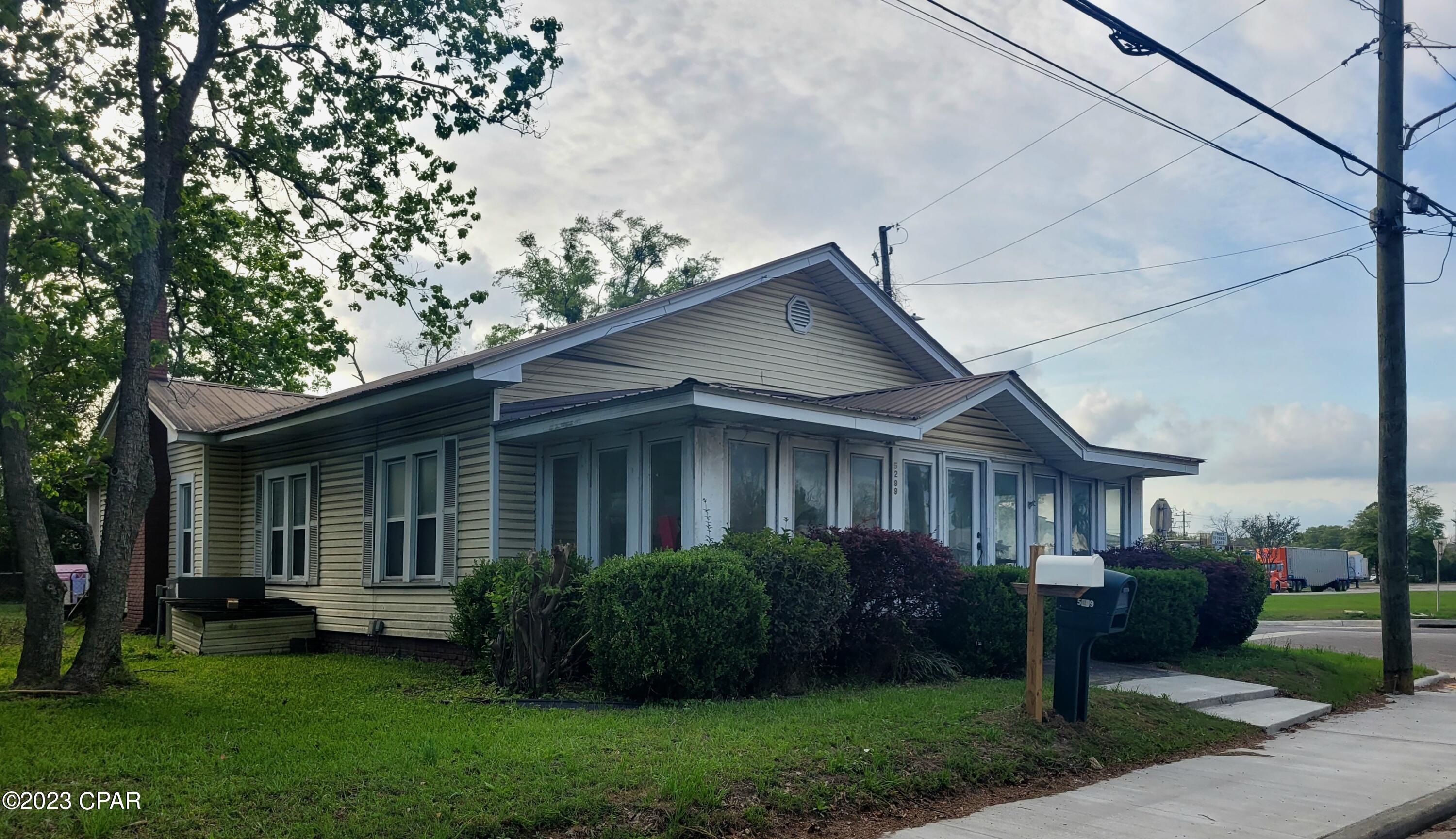 Very spacious 3 bedroom 2 bath home is located in the city limits of Graceville. Close to shopping and only an hour from the beaches! This home features hardwood floors, fenced in back yard, large deck and parking area, beautiful florida room streched over the front of the home and so much more!