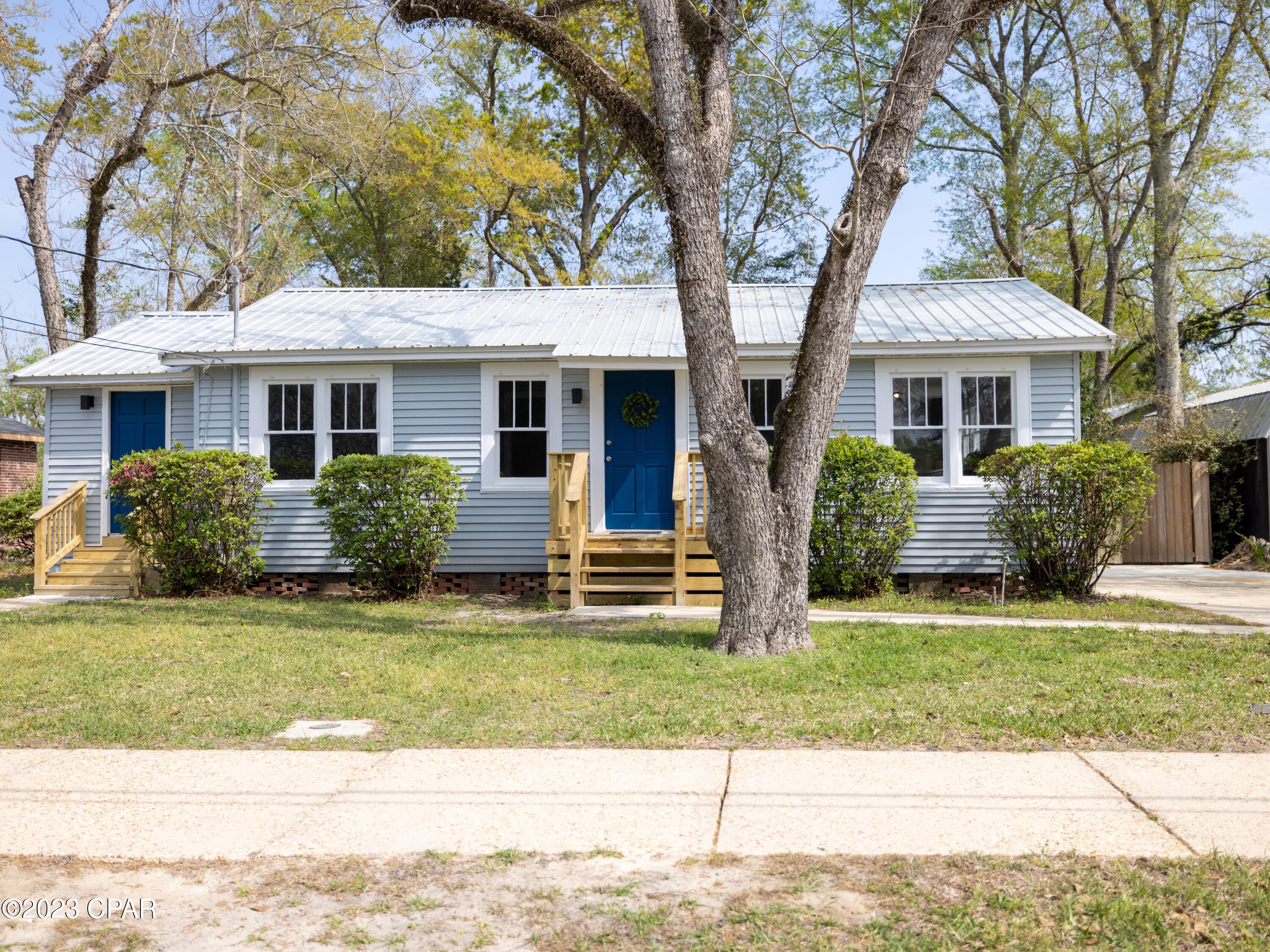 CHARMING COTTAGE!  Newly renovated with beautiful flooring, farmhouse light fixtures, fresh paint, updated closet shelves and a brand new front porch.  An abundance of natural light and a wonderful view from the kitchen and dining area.  The laundry room can also be a mud room entrance with doors leading to the front and back yards. The back deck is perfect for entertaining, grilling and enjoying the privacy of the fenced in backyard.  Extra storage is included with an outbuilding.  Located close to the shops and restaurants in downtown Chipley along with a nearby park.