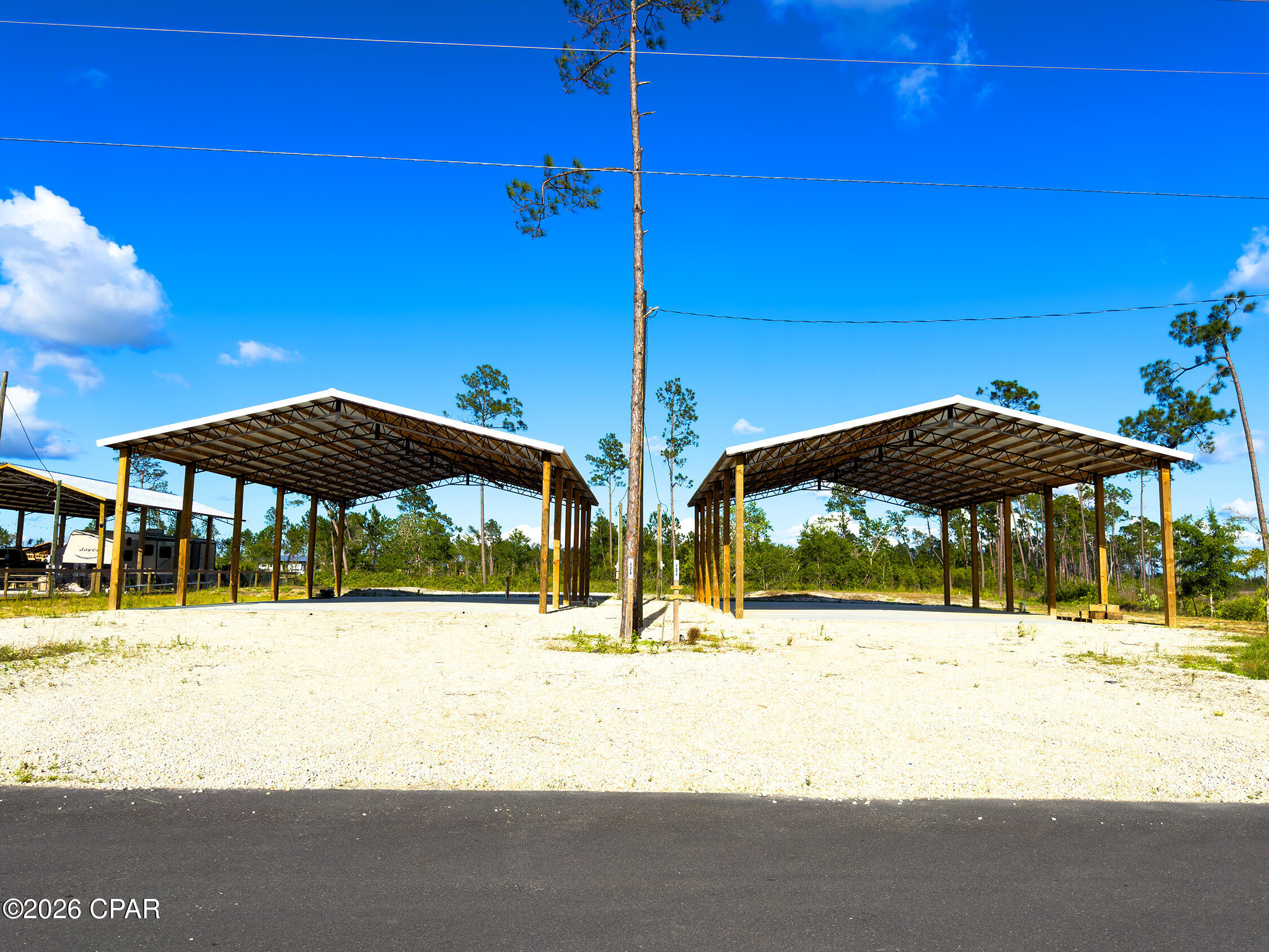 Own Your Piece of Florida's Forgotten Coast. Discover a rare opportunity to purchase two neighboring RV Approved Lots totaling .52 acres here in beautiful Gulf County, Florida. Located just 4 miles from white-sand beaches, world-class fishing, boating, and the laid-back charm of both Mexico Beach and Saint Joe Beach. These improved lots are ideal for Full-time RV living, vacation getaways, and rental income opportunities. Each lot has been meticulously finished to include a 40x60 Pole Barn, 6 inch concrete pad, 100 amp service with both 50 amp and 30 amp hookups, brand new septic systems, and city water. Live on one and rent the other, rent both, or turn both into the ultimate RV home base. Located within a mile of the Overstreet Boat Ramp, you can launch your boat onto the Intracoastal Waterway within minutes. Don't miss this opportunity to purchase these side by side RV Approved lots. *Each Lot is also individually available, see MLS #789921 & 789923 for details.*