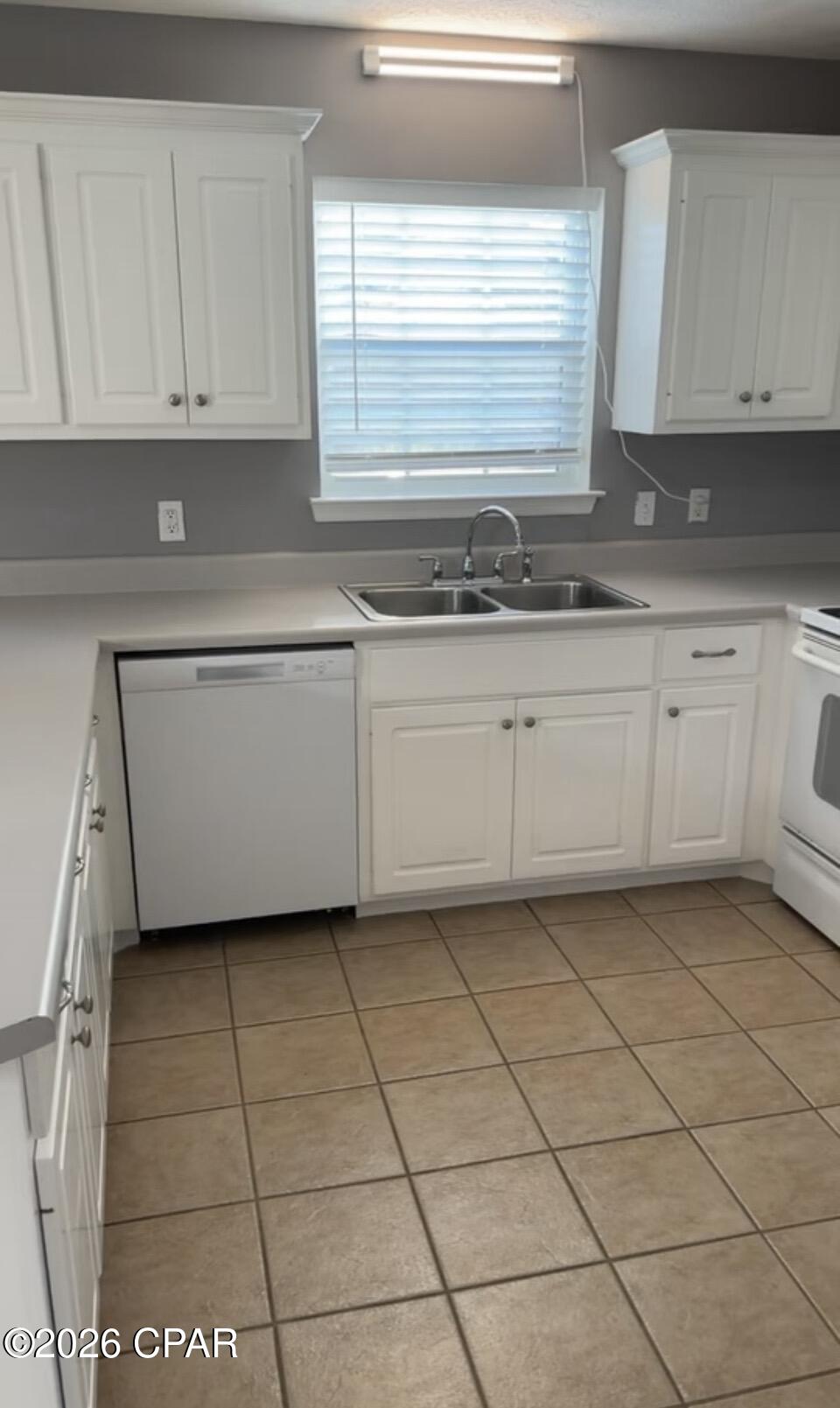 Welcome to your slice of paradise in Panama City Beach!  This 2/1.5 is located in the Heart of Panama City Beach. Just off of Thomas Dr. Across from the Naval Base.  Situated on a corner lot and has a privacy fenced backyard. The first floor has an open floor plan with the main living areas and half bath.  The upstairs has two bedrooms and full bathroom. The bedrooms are good sized with ample closet space. This is one you do not want to miss. Just minutes from the Sugar sand beaches of Famed Panama City Beach. Close to schools, shopping, restaurants, and more. Potential for an investment opportunity as the property is currently being rented through October 31, 2026.