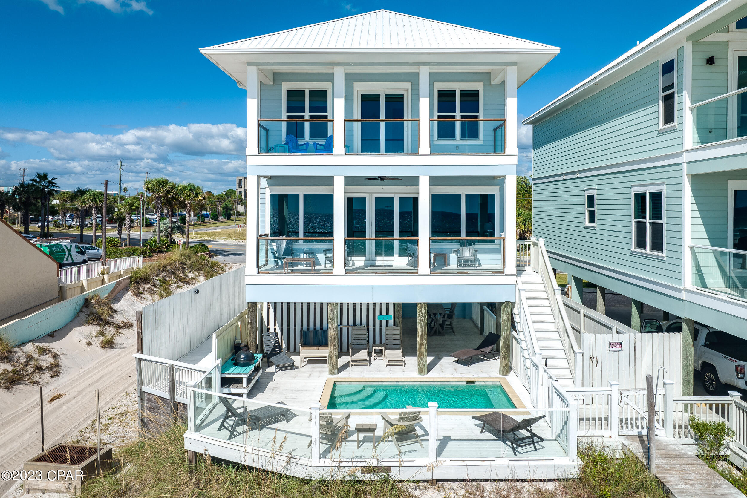 CURRENTLY UNDER CONTRACT, SELLER WILL CONSIDER BACKUP OFFERS **INCREDIBLE RENTAL POTENTIAL: $330K-$350K ANNUALLY BASED ON SIMILAR HOMES. CALL FOR DETAILS** Embrace modern coastal living with this stunning, fully-furnished, three-story gulf-front home, where breathtaking views green you on every level. With 5 bedrooms, 4 full baths, 2 half baths, and a private heated pool overlooking the Gulf, this home offers the ultimate beachfront experience. Recent upgrades and high-end furnishings enhance the home's contemporary charm. Each floor is adorned with new artwork and designer rugs, adding a touch of elegance throughout. The second and third floors feature new blinds, and the living room and third-floor patio boast stylish new furniture, including durable Polywood pieces in the pool area. The kitchen now features a new stainless steel stove, perfect for culinary enthusiasts. The second floor features an open-concept design, seamlessly blending the kitchen, dining, and living areas into a spacious and inviting space. This level also includes a queen bedroom with an ensuite bath and a convenient half bath. Step out onto the balcony to access your private walkover to the beach. The third floor houses four beautifully appointed bedrooms: a queen room with an ensuite, two queen floating bunk rooms (one with an ensuite), and the luxurious king-sized master suite with large ensuite bath and direct balcony access. A laundry room is also conveniently located on this floor. The home's interior and exterior have been recently repainted, ensuring a fresh look. Don't miss your chance to own your place on the beach today! Call us for a private tour!