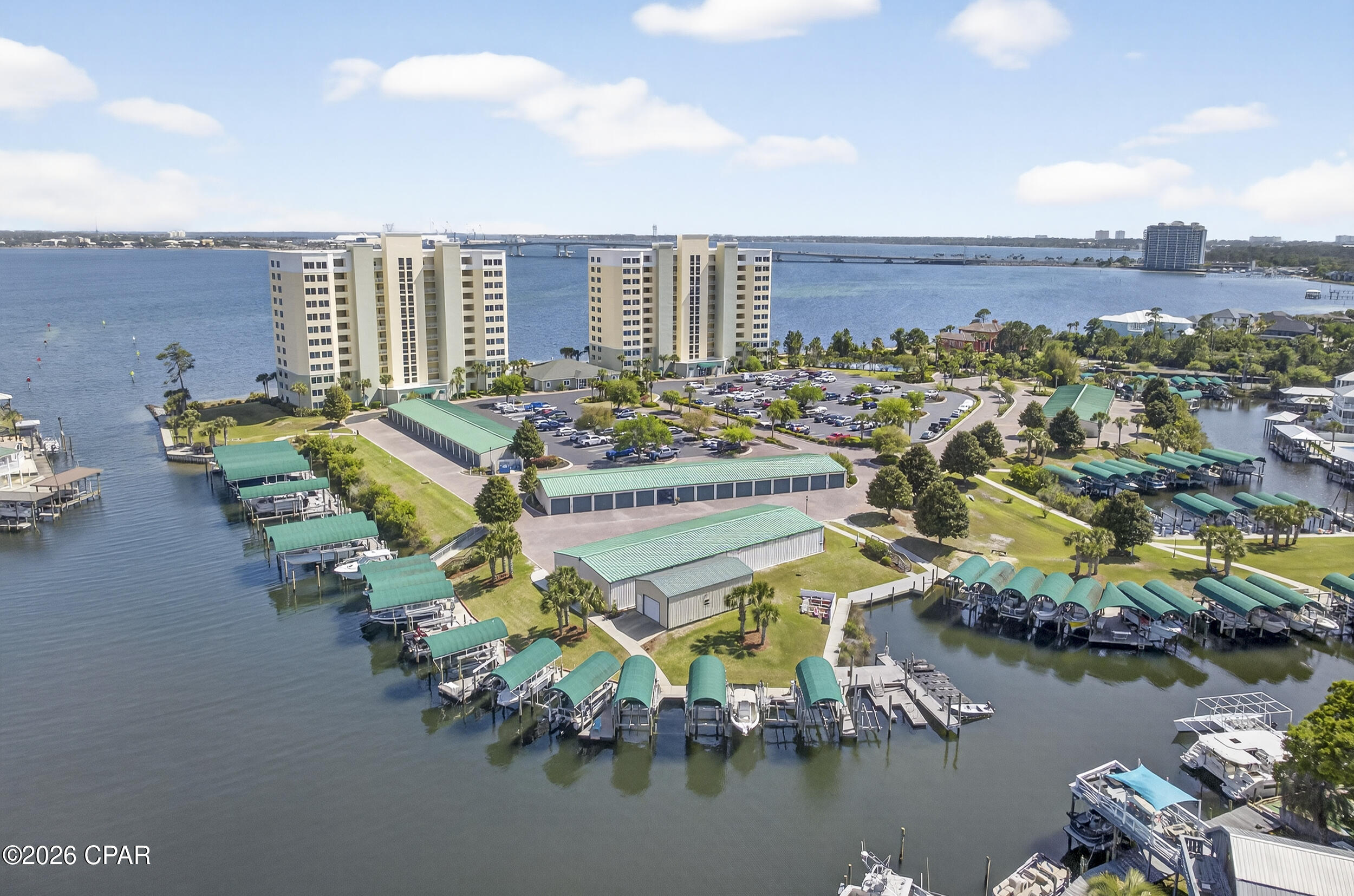 Waterfront living with beautiful views- this community has it all: boat slips and garages (for sale or rent); jet ski slips; over 400' ft fishing pier; gilling stations; tennis or pickleball court, fire pit; and walkway stairs into the gulf for your paddle board or kayak; plus you are just minutes from Shell Island and the pass out to the Gulf! This gorgeous home has been beautifully renovated with a spacious utility room for the washer/dryer and plenty of shelving, There is also a separate pantry for extra food storage. The kitchen features plenty of cabinets with quartz countertops; stainless appliances; dining area for entertaining; and separate sitting area. The large open great room boasts an inviting balcony with a stunning view of the bay. The balcony sliders are hurricane rated and were replaced last year. The sunrises are magnificent! The huge primary bedroom features custom paint color, trey ceiling and another amazing view of the bay and primary bath with jacuzzi tub, separate shower and double vanities. The secondary bedroom is quite spacious and has a full bathroom just steps away. This amazing home also features LVP flooring throughout and lovely custom paint. Another amazing feature of this lovely condo is that it comes completely furnished! The community completed the Structural Integrity study and invested millions in improvements with no extra cost to the residents - including the recent renovation of the pool deck with exquisite Travertine Tile. The amenities also include a community room for gatherings; a gym; and a tranquil library for reading or working in a peaceful area at no extra cost to residents.  There are no short term rentals which help keep this community a more relaxed lifestyle with an atmosphere of unity and long term friendships. The HOA includes water, garbage, pest control, high speed internet which includes over 100 free TV channels- including HBO, Showtime, and Starz. The HOA also includes a gated entrance, and cameras for security. This community is truly an exceptional place to live!