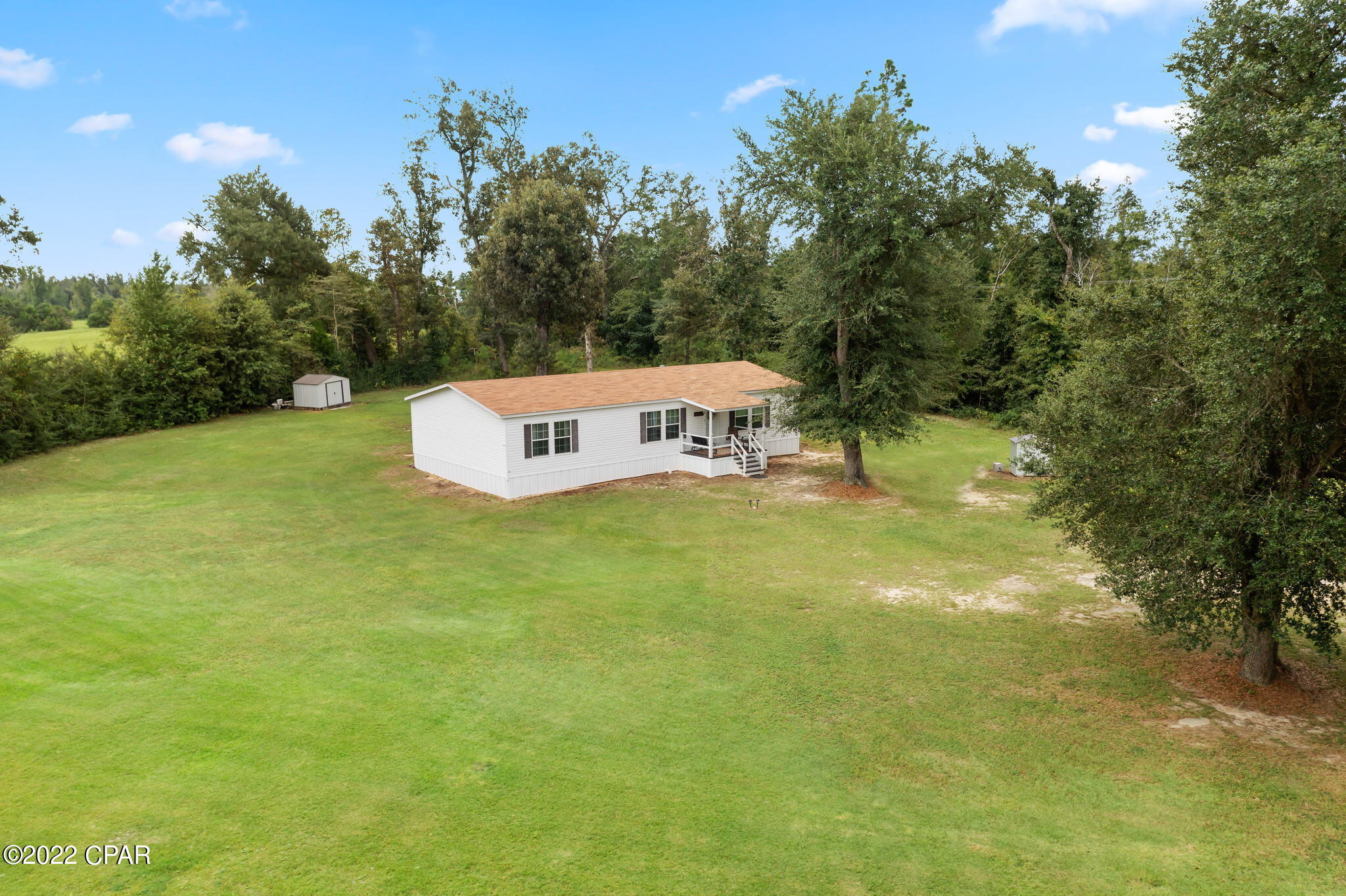 CURRENTLY UNDER CONTRACT, SELLER WILL CONSIDER BACKUP OFFERS. IMMACULATE COUNTRY HOME on a spacious corner lot paved road frontage!!! This beautiful, partially furnished home has been well maintained and has an open concept living, kitchen and dining area with a split bedroom floor plan.   The kitchen has a breakfast bar and a large hidden laundry room which leads to an open deck for relaxing and entertaining.   This home is minutes from Hwy 231 and I-10 and would be the perfect place if you have been looking for something with a little acreage.  Don't delay, contact your favorite realtor today for a showing!