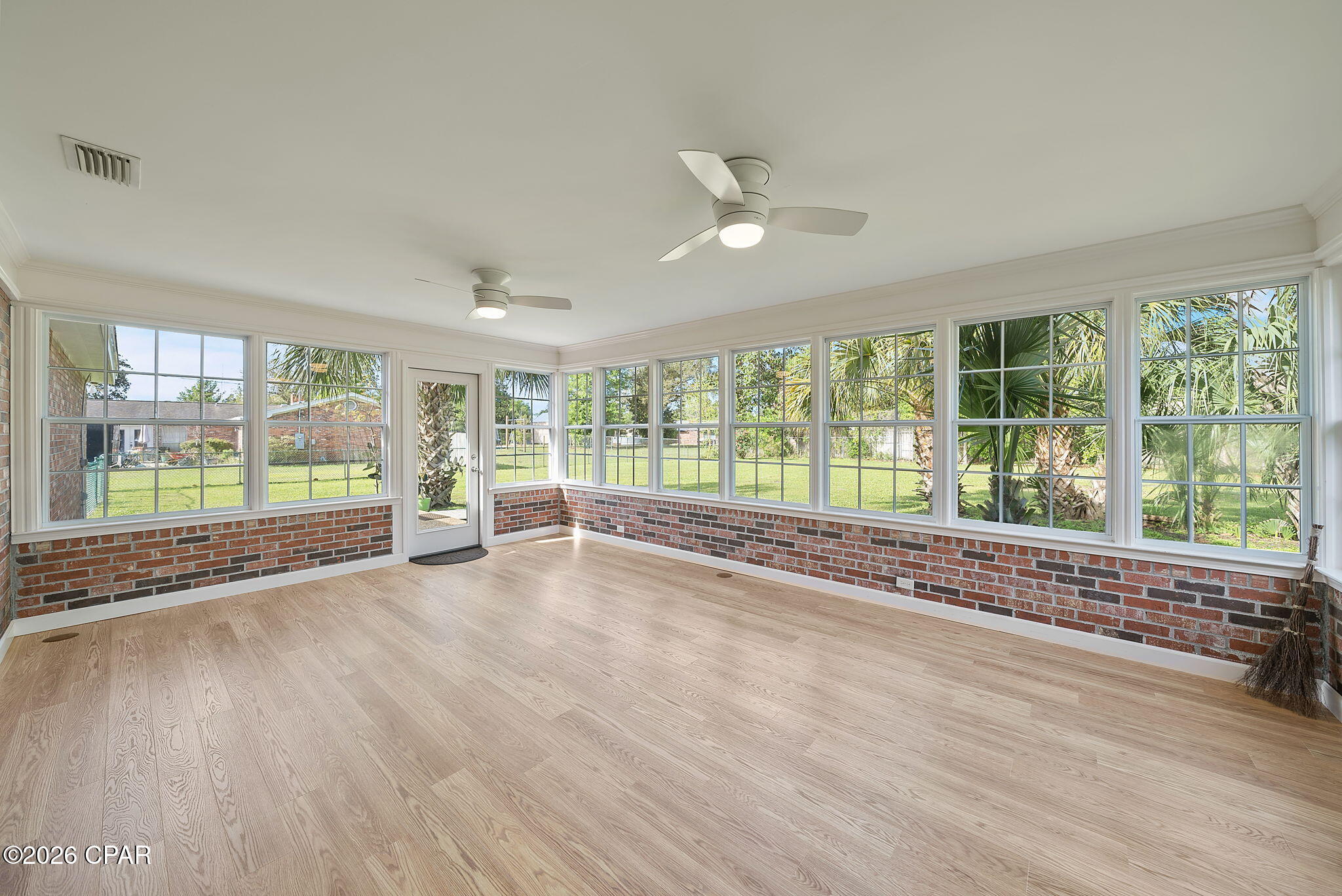 Located in the heart of a well-established Lynn Haven neighborhood, this charming traditional home at 4401 Cindy Lane offers a refreshing alternative to the modern open floor plan. Spanning 3,374 square feet, the layout features intentional, defined spaces and multiple flex rooms that provide privacy and endless options for a home office, gym, or hobby suite. The interior has been freshly painted, highlighting classic architectural details like the beautiful wood-burning fireplace that serves as the home's cozy centerpiece. The true showstopper is the completely enclosed sunroom, which is flooded with natural light and offers a serene, versatile sanctuary for year-round enjoyment. With four spacious bedrooms and two bathrooms, there is plenty of room to grow within this character-filled residence. Beyond the front door, you are perfectly positioned near local shops and dining, with easy access to Hwy 390 for a quick drive to the beach. This home is a rare find for those who appreciate classic charm and the luxury of having a dedicated place for everything. This home is MOVE-IN READY! The home inspection has been done and everything has been repaired. It's been painted, professionally cleaned, and is ready to go!  The homesite is just short of 1/2 acre with fenced backyard and NO HOA or dues!