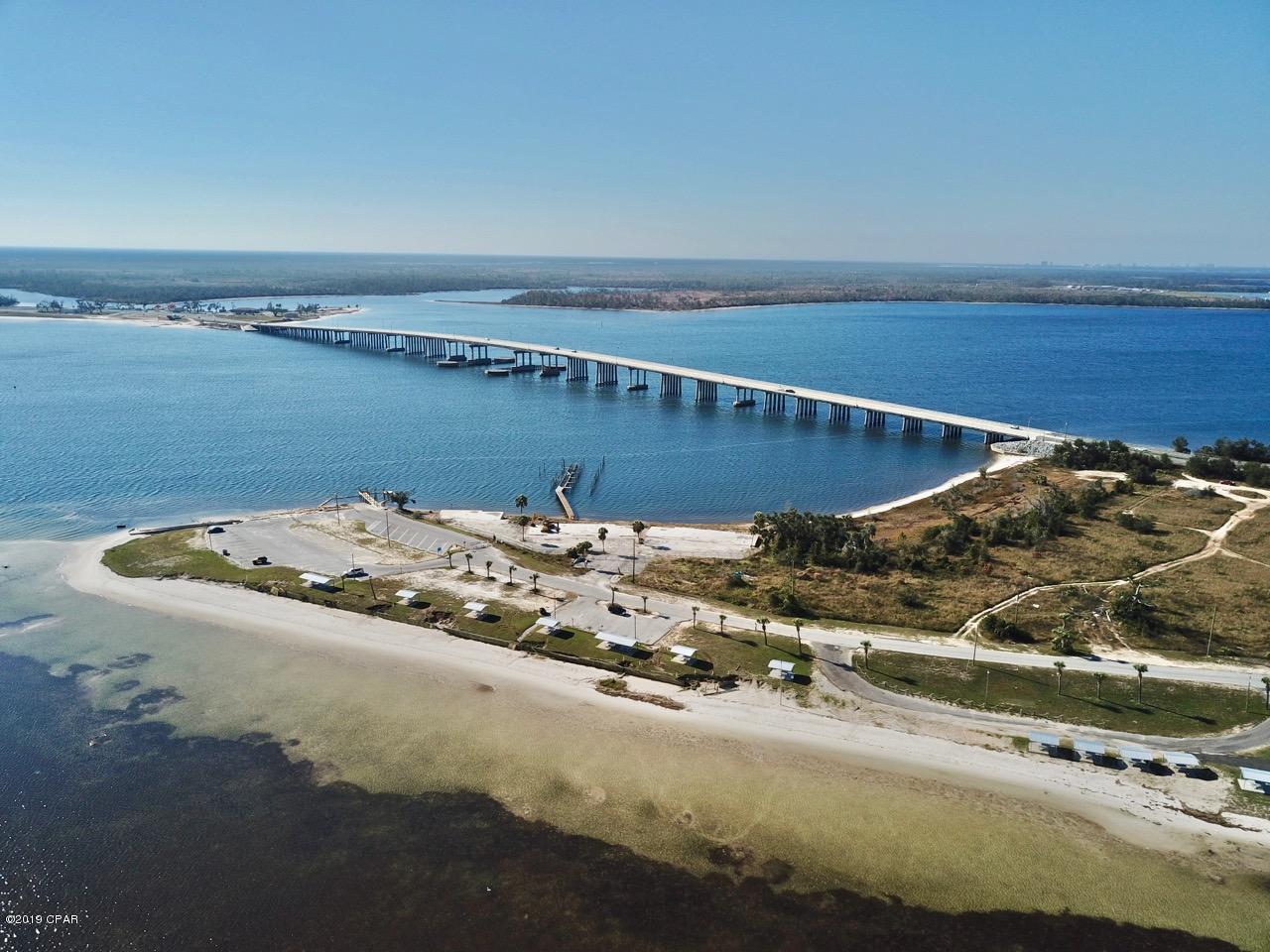A rare Redevelopment Opportunity located on the east side of St. Andrews Bay with deep water boat slippage.  The site of Long Point Condominium complex sits on the Northwest side of a peninsula with calm water and presents many options for a new owner.  Its currently zoned Mixed Use, and it adjoins Earl Gilbert State Park's public boat launch and its white sandy beaches.  This 1.48 acre parcel is located at the foot of Tyndall bridge with quick boating access to the Gulf of Mexico.  The buildings were damaged beyond repairs and now it's time for some lucky developer to rebuild.