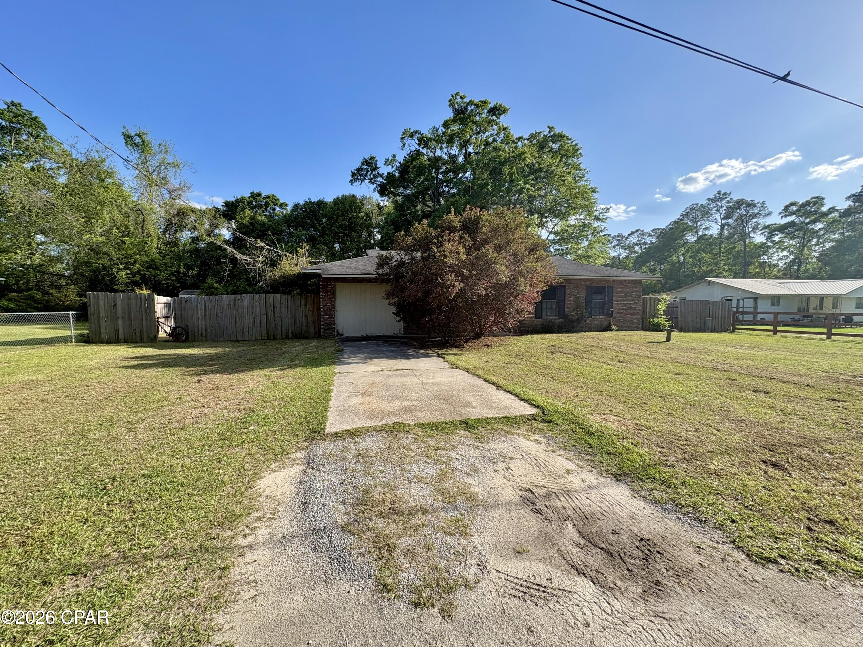 Solid brick home on a slab located in the city limits of Chipley. This 1992 home features 3 bedrooms with another room that could serve as a fourth, one bathroom, and an inside laundry room. There is a large backyard that is mostly privacy fenced and a spacious screened back porch. Updates include a shingle roof put on in 2017 and a central a/c in 2018. Brand new carpet was just installed in all of the bedrooms. There are also solar panels on the home that will be completely paid off at closing, enjoy lower power bills!  If you're looking for your own home, it will be cleaned out and ready to go upon closing. If you're looking for an income producing opportunity; with tenants already in place, this could be a great opportunity to add a rental to your portfolio that is already producing. Cash or conventional financing only.