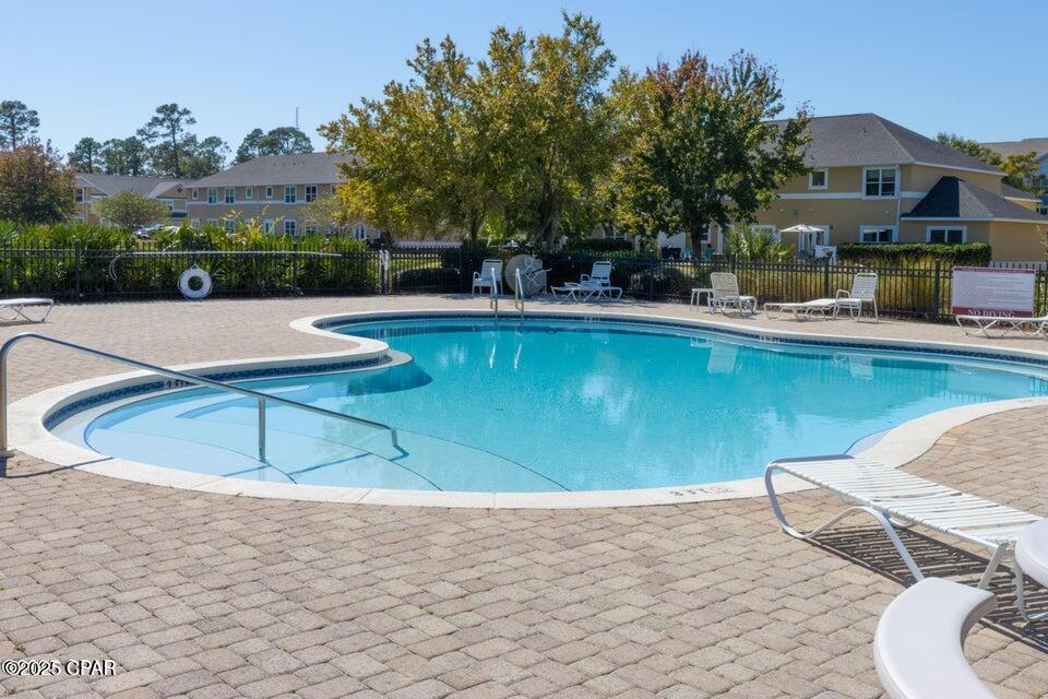 Welcome to Annabella's Townhomes—one of Panama City Beach's most desirable gated communities. This beautifully maintained 2-bedroom, 2.5-bath townhome offers a spacious, open layout and a comfortable place to call home. The first floor features an inviting open-concept design with new carpeting, a well-appointed kitchen, a convenient laundry room, and a half bath for guests.

Upstairs, you'll find two generously sized bedrooms, each with its own private en-suite bathroom, providing privacy and functionality for both residents and guests. This home has been exceptionally well cared for and is move-in ready.

Annabella's is a sought-after community offering a gated entrance, a sparkling community pool, and a prime location near shopping, dining, and the beach. Homes in this subdivision don't last long—don't miss your opportunity to own this charming townhome.