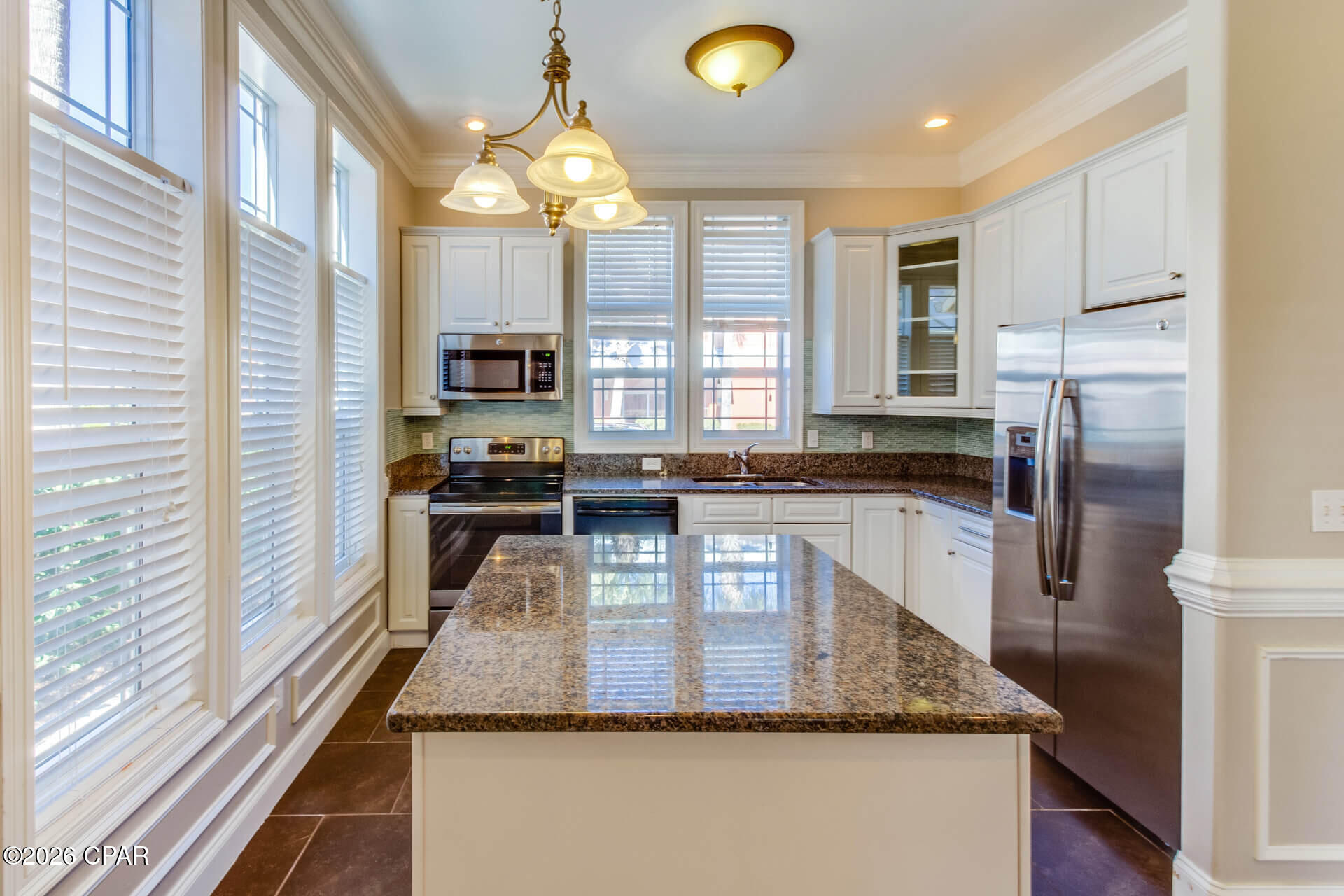 End-unit 3BR/2.5BA townhome in highly desirable Coral Bay Village on the West End of Panama City Beach -- just a short walk, bike ride, or golf cart drive to the Gulf of Mexico. Prime location near Scenic 30A, Lake Powell, Pier Park, shopping, dining, entertainment, and Northwest Florida Beaches International Airport. This former model home offers an open, light-filled floor plan with elevated windows and thoughtful upgrades throughout. The first floor features a private bedroom with en-suite bath, additional half bath for guests, spacious living and dining area, and a private patio overlooking the community pool. The kitchen includes granite countertops, and washer/dryer are included. Upstairs includes two spacious bedrooms connected by a Jack-and-Jill bath, 12-foot ceilings, and a Juliet balcony. Hardwood stairs, updated flooring, fresh paint, crown molding, and custom trim details enhance the home's appeal. Coral Bay Village is a Mediterranean-style community with brick-paved streets, landscaped grounds, and a community pool. Lawn care, pool care, and garbage service are included in rent for low-maintenance coastal living. Pet friendly with owner approval and non-refundable pet fee. If you're looking for a Panama City Beach rental near 30A, Pier Park, and the beach, this West End townhome offers the perfect combination of location, design, and convenience.