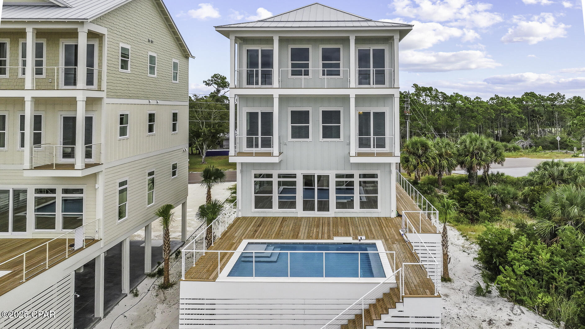 ULTIMATE GULF FRONT HOME! Nestled on pristine Gulf front sand, 295 Watermark Way offers the ultimate coastal escape-where turquoise waves, sugar-white beaches & unforgettable sunsets set the stage for lifetime memories. This brand-new custom beachfront build, within the serene lower-density stretch of St. Joe Beach, effortlessly combines luxury, comfort & coastal charm. With six beautifully appointed suites, this home is perfect for multi-family vacations or large groups seeking space, style & shared experiences. Each beachfront king suite opens onto its own deck, allowing you to  awake to sea breezes and Gulf views. The homes best feature is a private heated pool just steps out the door to be enjoyed year round. The soaring open living spaces, gourmet kitchen & soft coastal finishes evoke easy elegance. The layout is designed for joyful mingling where you enjoy panoramic Gulf vistas from every level & wide decks that connect you to the horizon. An elevator provides smooth access across all floors. Beyond the walls of this spectacular home, you'll find immediate access to the Gulf with a private boardwalk & steps to powdery sand.   Hop in your golf cart or go for a peaceful bike ride along the paved paths to Windmark Beach where you will find fun, food, and entertainment for the whole family.   A short ride into Port St Joe connects you with  boutique shopping, fresh seafood restaurants, a bustling marina, and a charming historic district. Whether you're planning an epic family retreat, a generational reunion, or a carefree getaway with friends, this home is built to host in style. From sunrise yoga to cocktail hour on the deck, to late-night stargazing by the sea—every moment unfolds with elegance and ease. Call for your private tour & LIVE THE BEACH LIFE!